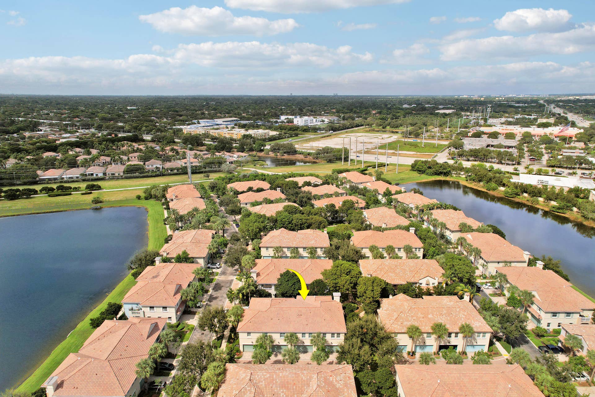 4326 Cascada Circle, Hollywood, FL 33024 Aerial perspective of multi-family residences featuring clay tile roofs, textured stucco exteriors, and surrounding waterfront scenery