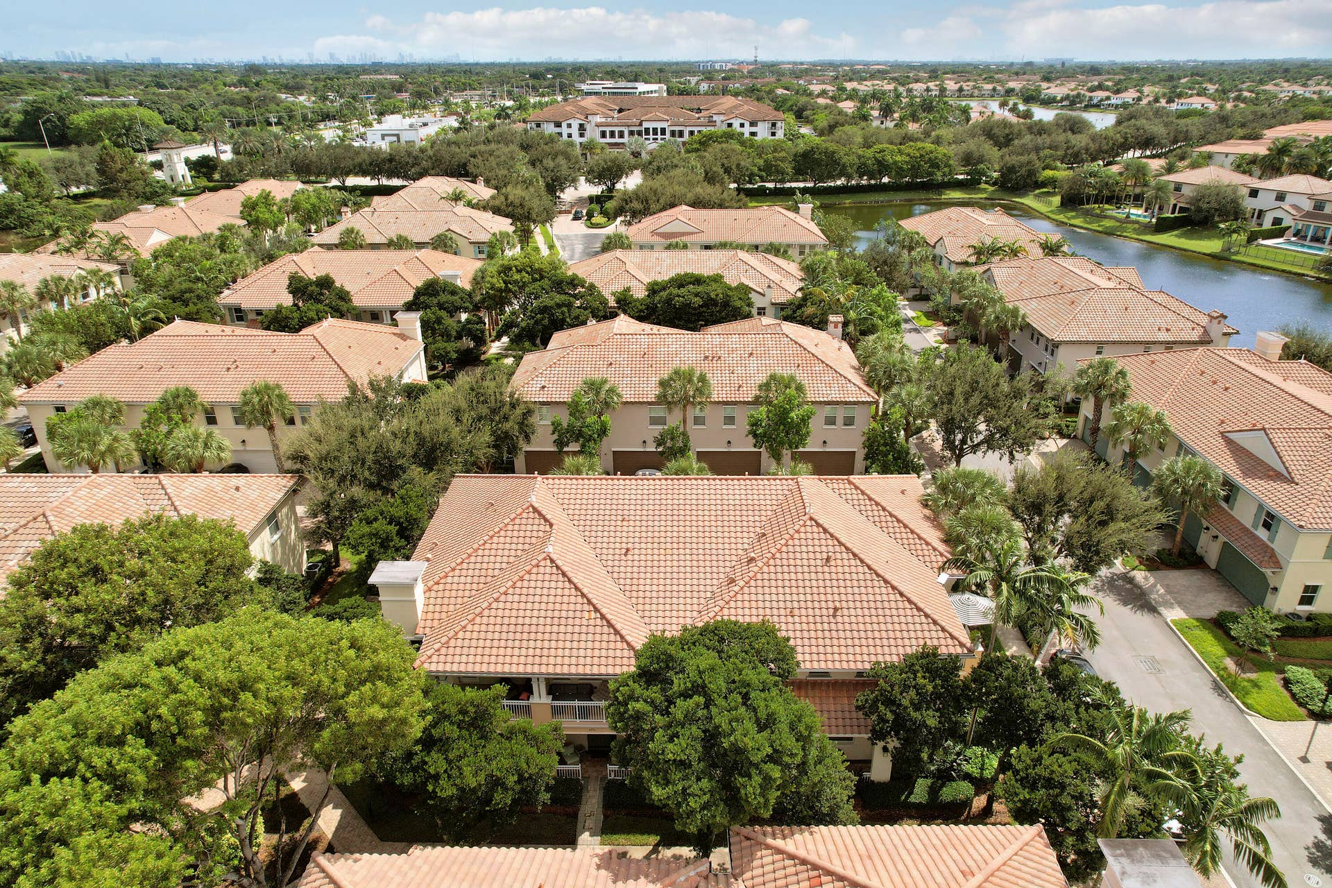 4326 Cascada Circle, Hollywood, FL 33024 Aerial perspective of residential community featuring terra-cotta tile roofing, mature landscaping, and winding paved streets