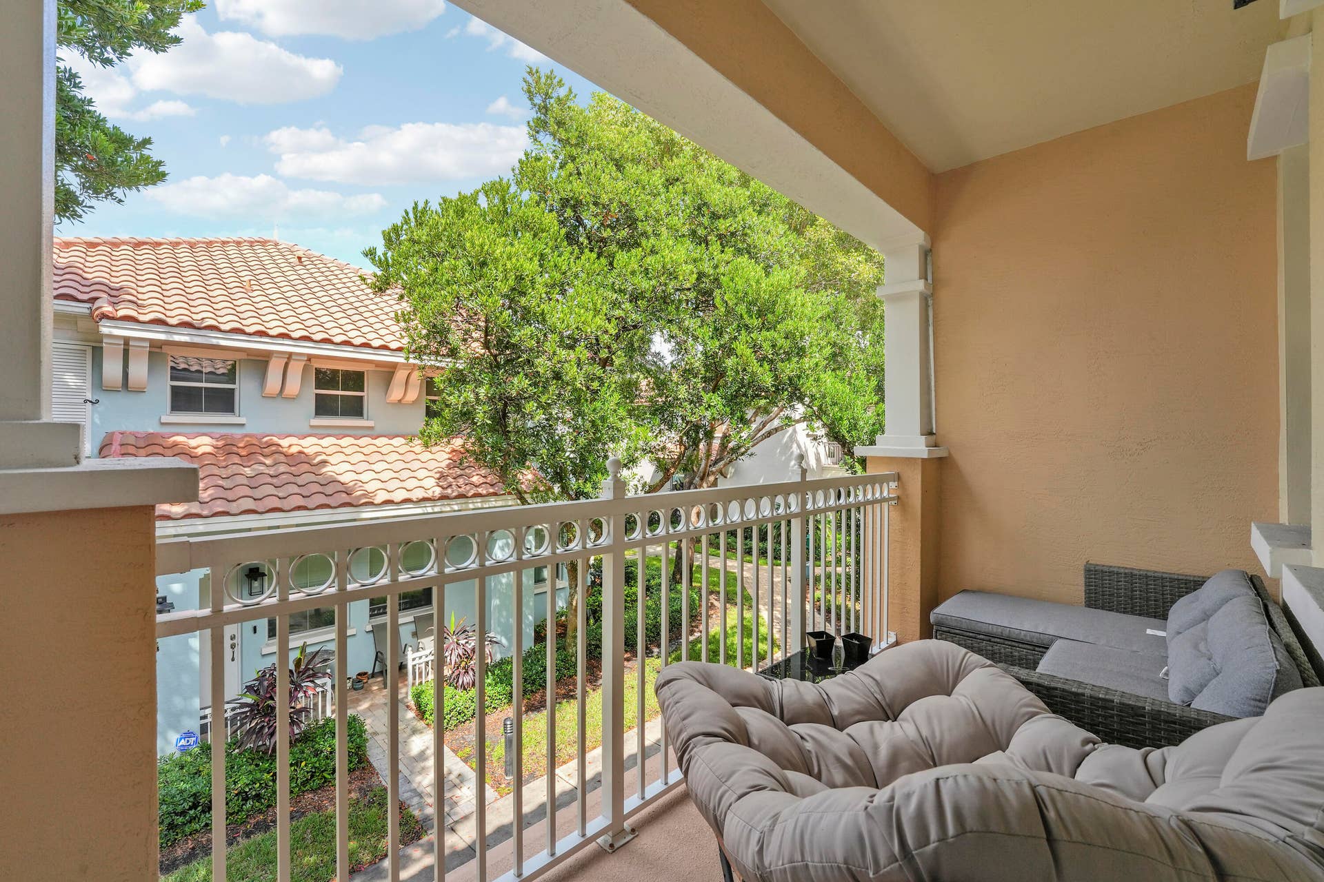 4326 Cascada Circle, Hollywood, FL 33024 Covered balcony featuring white metal railings, architectural columns, and neutral-toned wall finishes