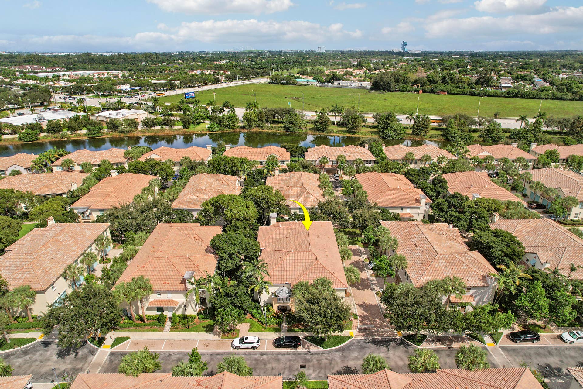 4326 Cascada Circle, Hollywood, FL 33024 Aerial perspective of a multi-unit residential property featuring terra cotta tile roofing, mature landscaping, and an attached driveway