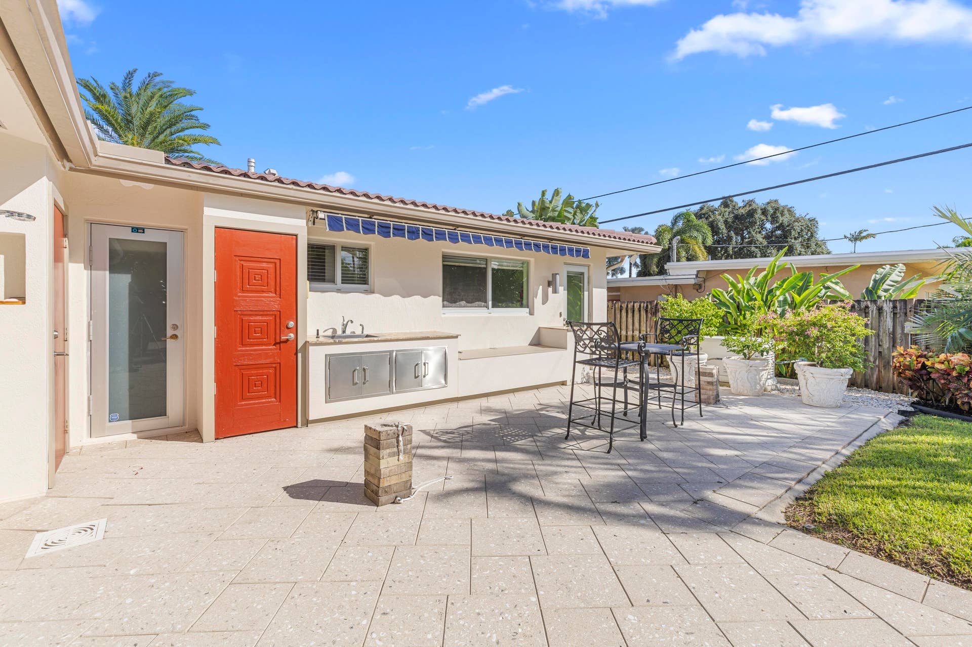 2317 NW 6th Avenue, Wilton Manors, FL 33311 Outdoor patio featuring paver flooring, built-in stainless steel cabinetry, integrated sink, and retractable awning