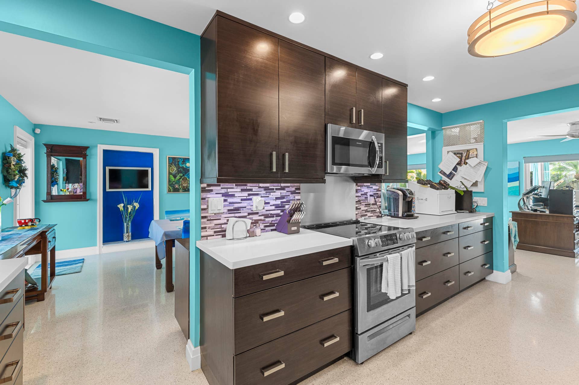 2317 NW 6th Avenue, Wilton Manors, FL 33311 Kitchen featuring dark wood-finish cabinetry, quartz countertops, stainless steel appliances, a multi-toned tile backsplash, and recessed lighting