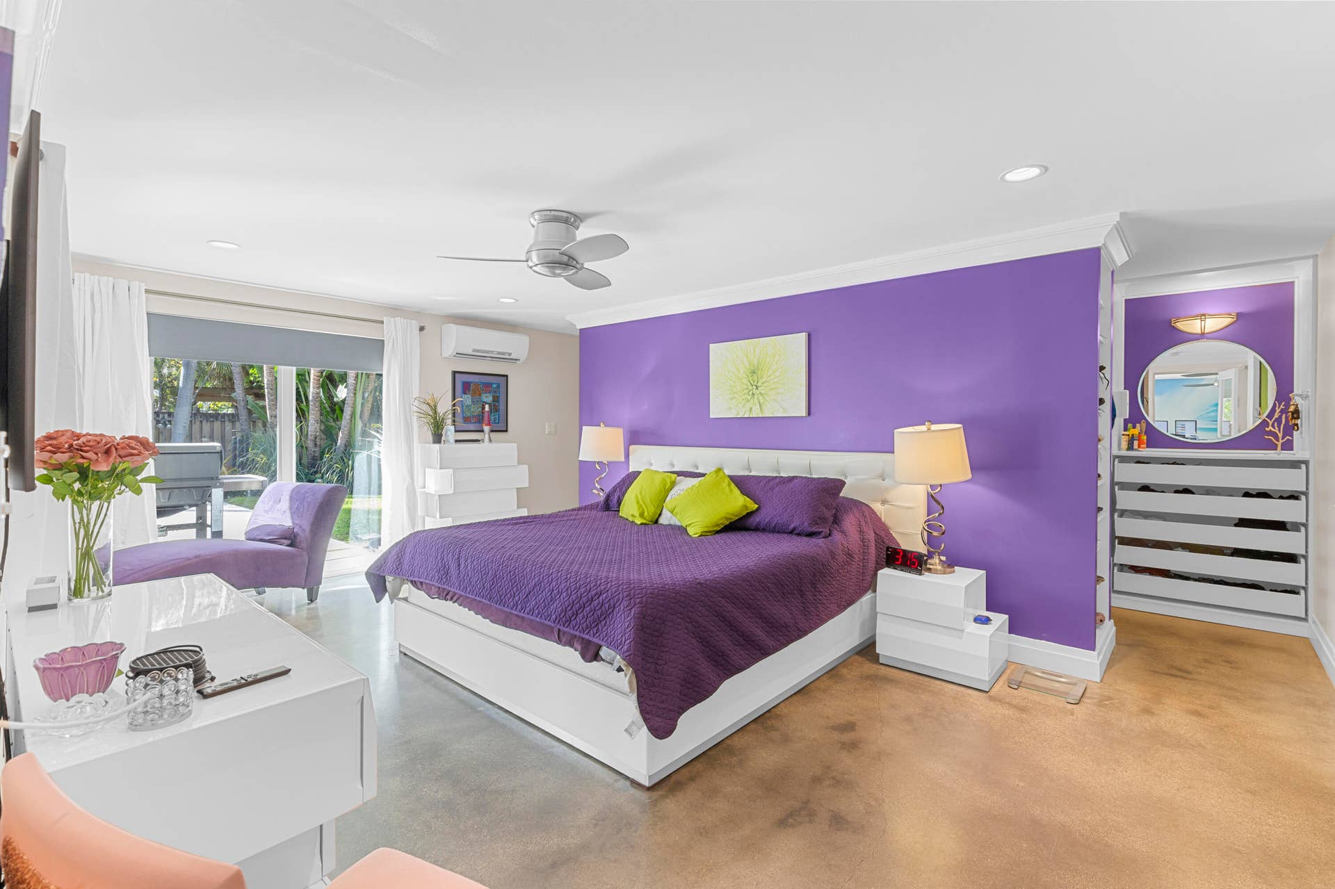 2317 NW 6th Avenue, Wilton Manors, FL 33311 Bedroom featuring polished concrete flooring, a ceiling fan, recessed lighting, a wall-mounted climate control unit, and built-in shelving with an integrated mirror