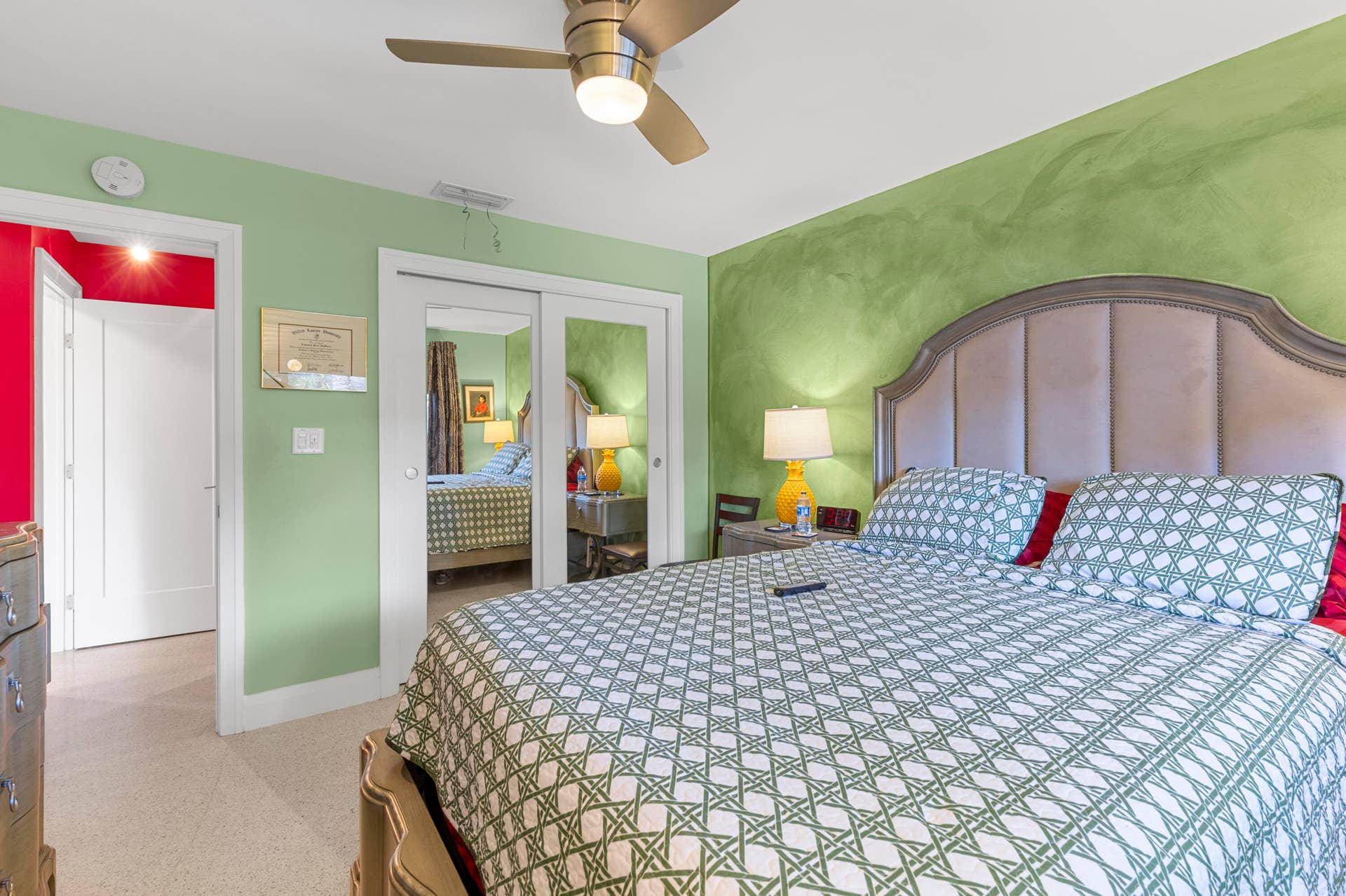 2317 NW 6th Avenue, Wilton Manors, FL 33311 Room featuring a brushed-finish metal ceiling fan with integrated lighting, dual sliding mirrored closet doors, and solid-core interior doors