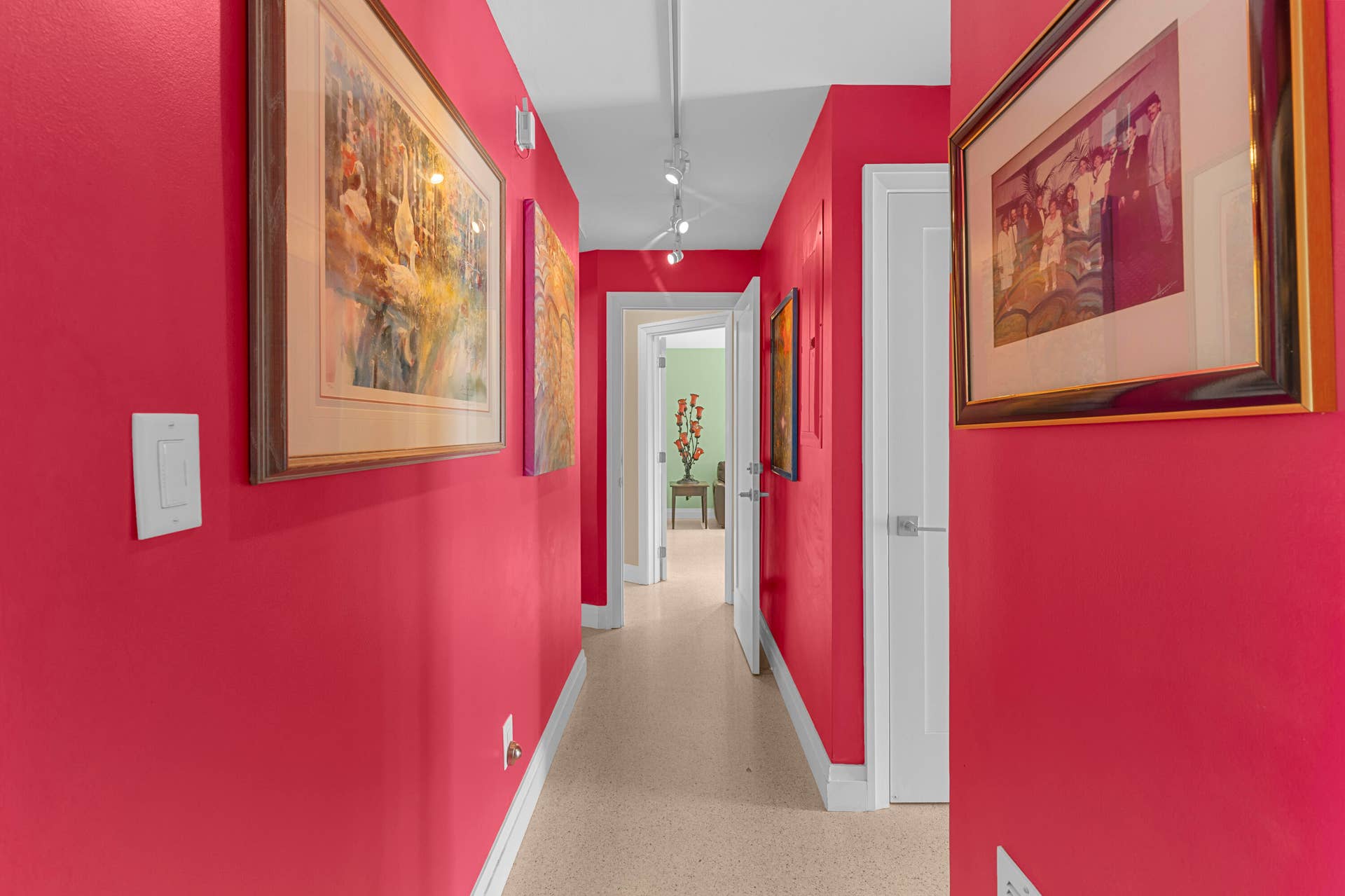 2317 NW 6th Avenue, Wilton Manors, FL 33311 Hallway featuring solid-core paneled doors, neutral flooring, and overhead track lighting