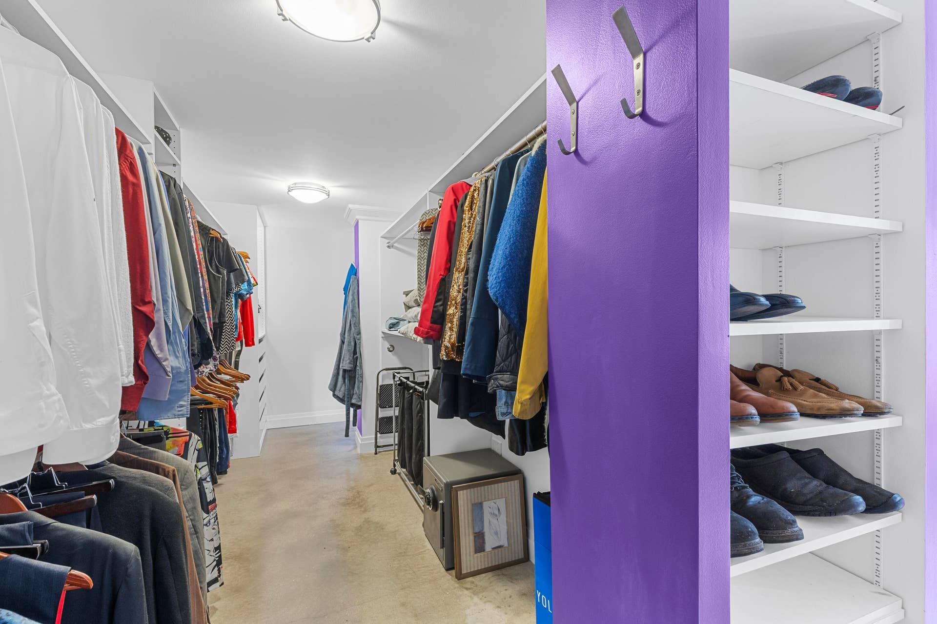 2317 NW 6th Avenue, Wilton Manors, FL 33311 Walk-in closet featuring extensive built-in shelving, adjustable hanging rods, flush-mount ceiling lighting, and wall-mounted storage hooks