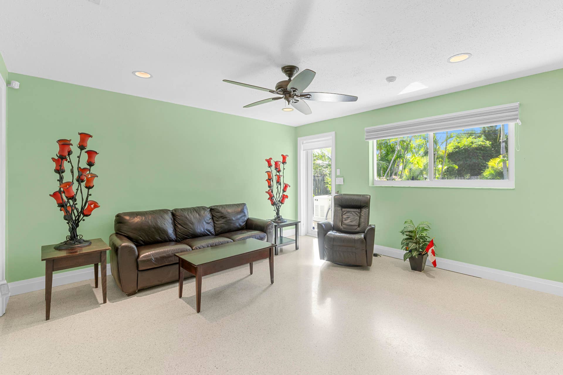 2317 NW 6th Avenue, Wilton Manors, FL 33311 Interior space featuring polished concrete flooring, recessed lighting, a ceiling fan, and a wide horizontal window with an integrated blind
