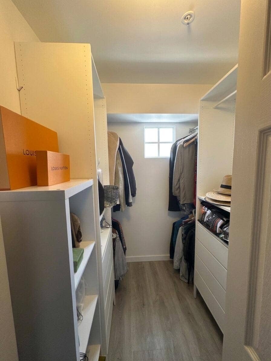 2941 NE 185TH Street, #1303, Aventura, FL 33180 Walk-in closet featuring white built-in shelving, integrated storage drawers, hanging rods, wood-finish flooring, and a single-pane window