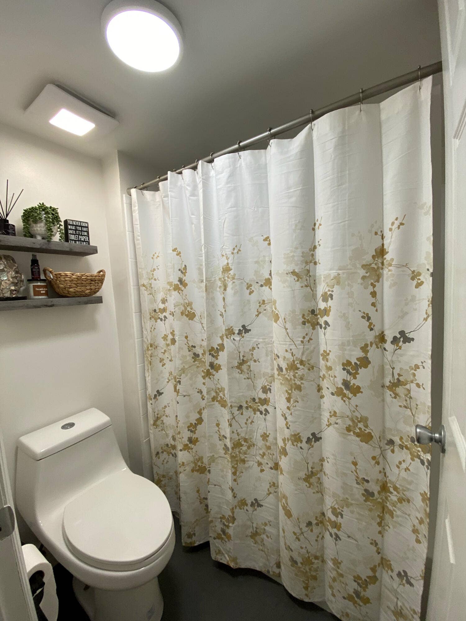 2941 NE 185TH Street, #1303, Aventura, FL 33180 Full bathroom featuring a high-efficiency dual-flush toilet, recessed ceiling lighting, a shower enclosure with a stainless steel tension rod, and dual wall-mounted floating shelves