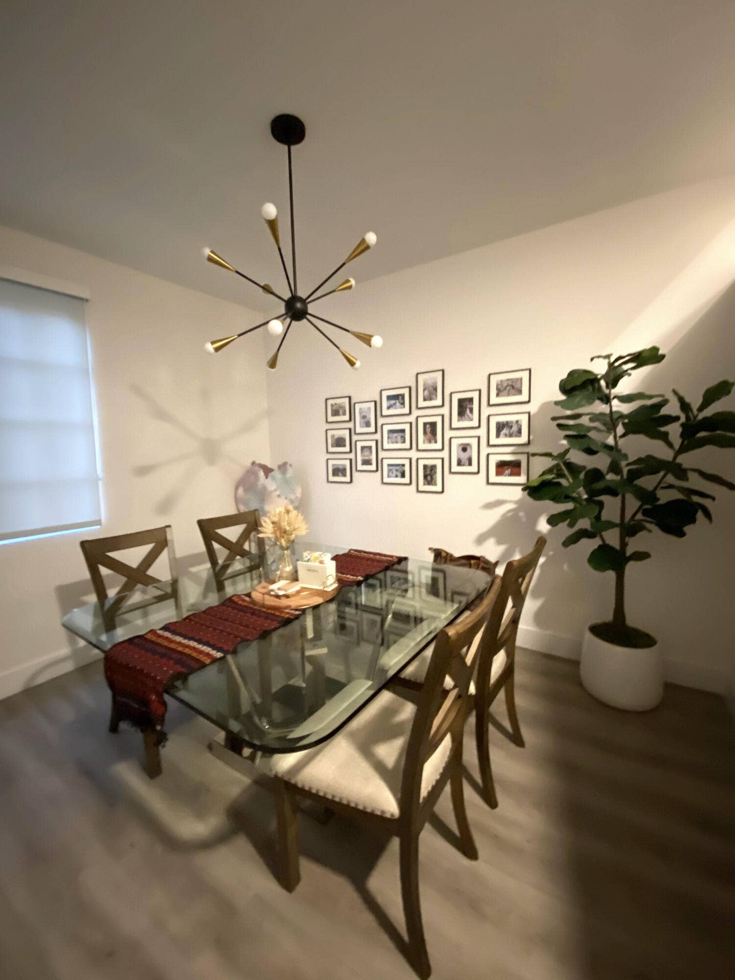 2941 NE 185TH Street, #1303, Aventura, FL 33180 Modern sputnik-style chandelier with a matte black and metallic finish, paired with wood-finish flooring and a neutral color palette