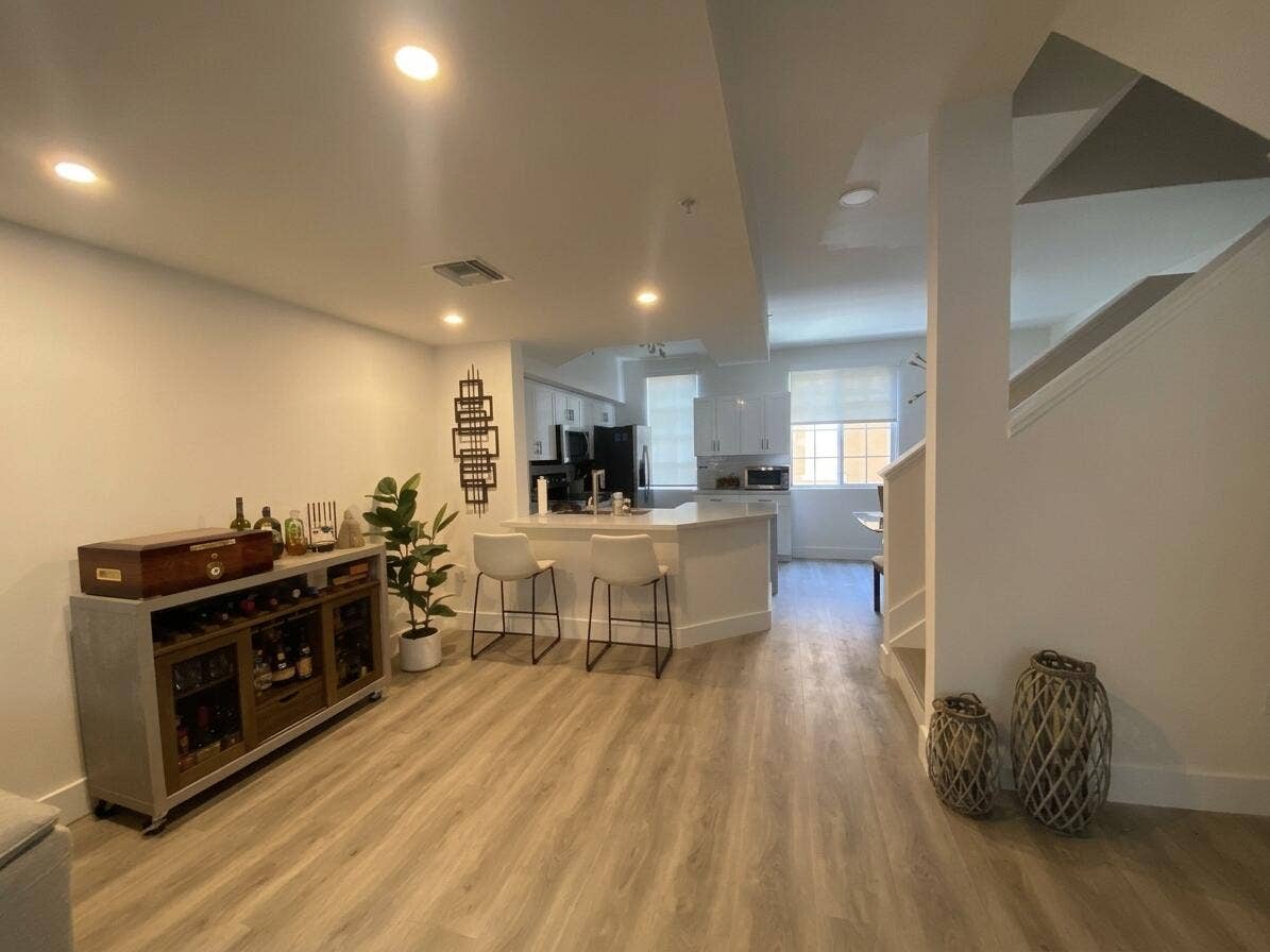 2941 NE 185TH Street, #1303, Aventura, FL 33180 Open-concept interior featuring wood-finish flooring, recessed lighting, white cabinetry, and a peninsula with a countertop