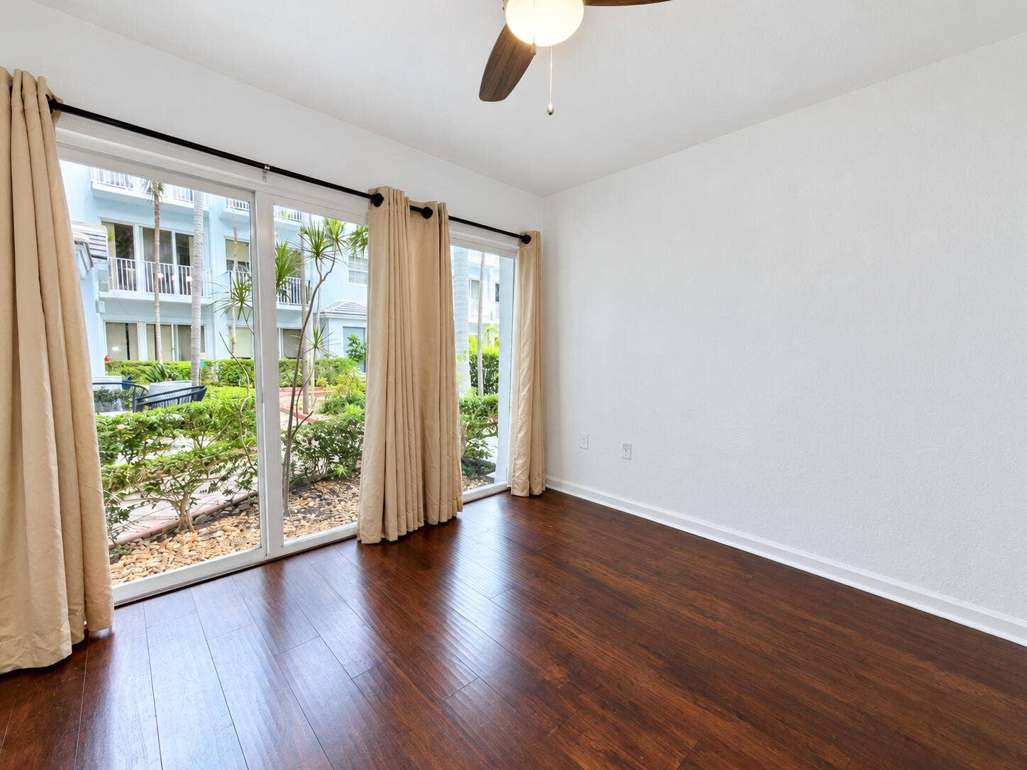 2725 NE 8TH Avenue, #112, Wilton Manors, FL 33334 Brightened living room with courtyard vi