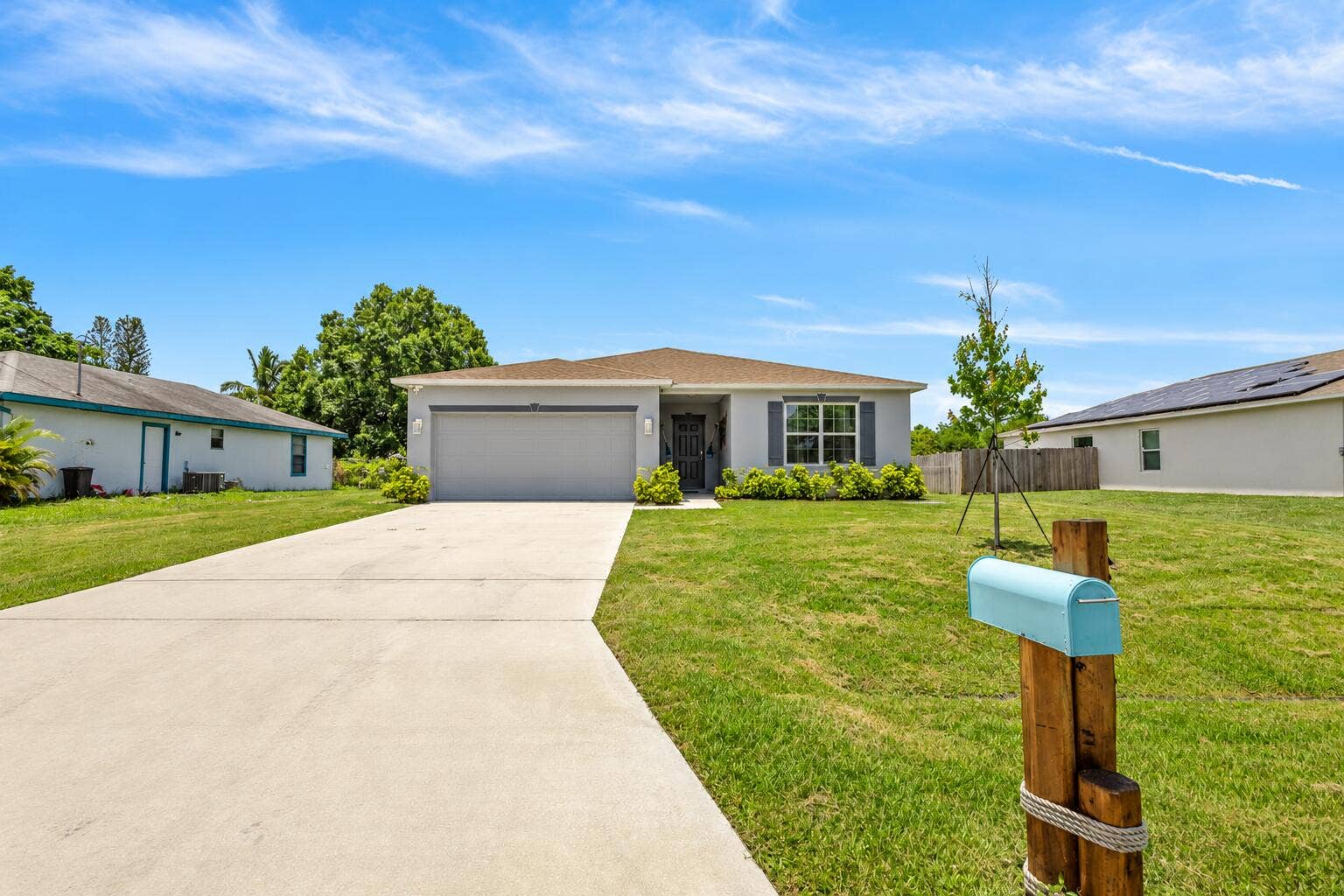 Sunny Gray Ranch Home with Aqua Mailbox