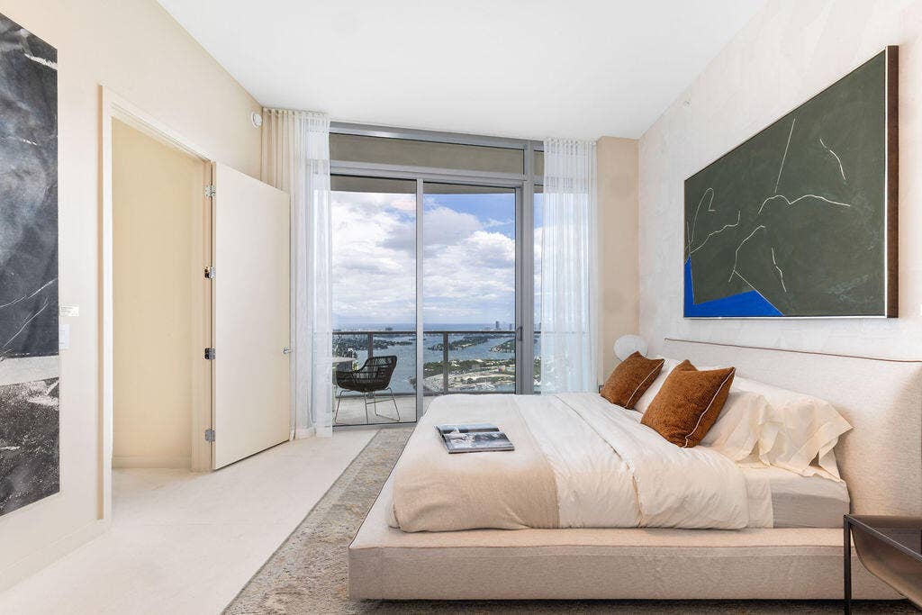 Floor-to-ceiling sliding glass door, private balcony, and light-toned flooring