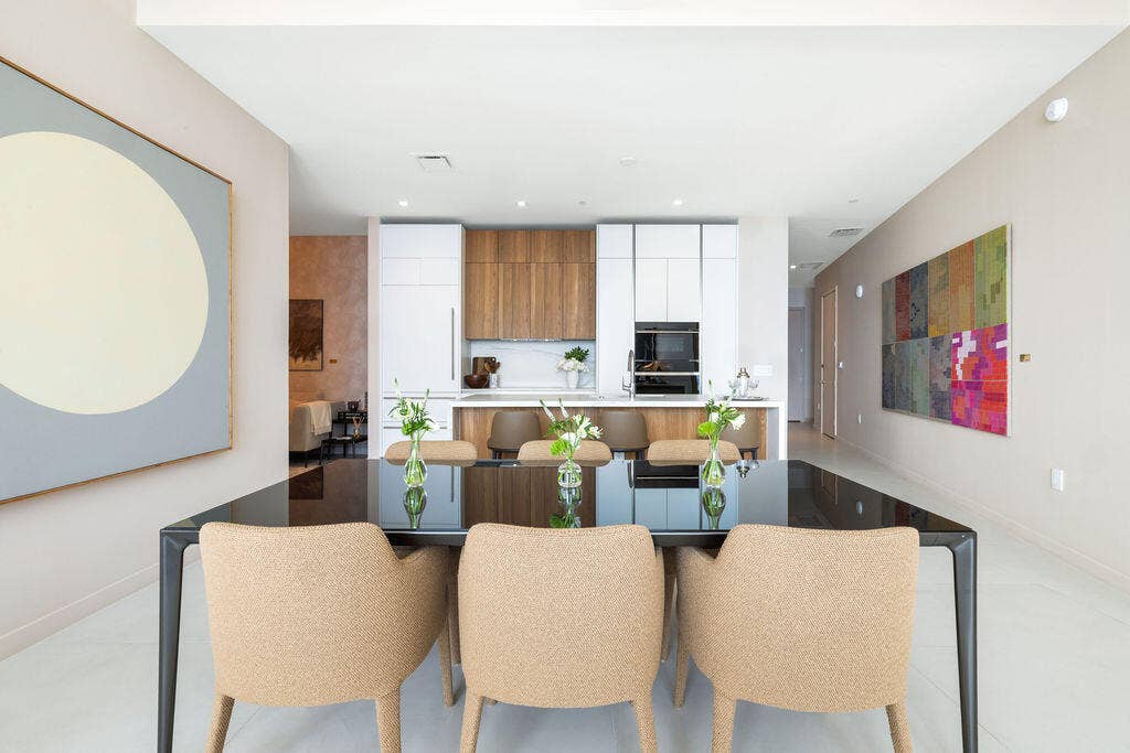 Kitchen featuring floor-to-ceiling cabinetry, wood-finish accents, a peninsula with stone countertop, and built-in appliances