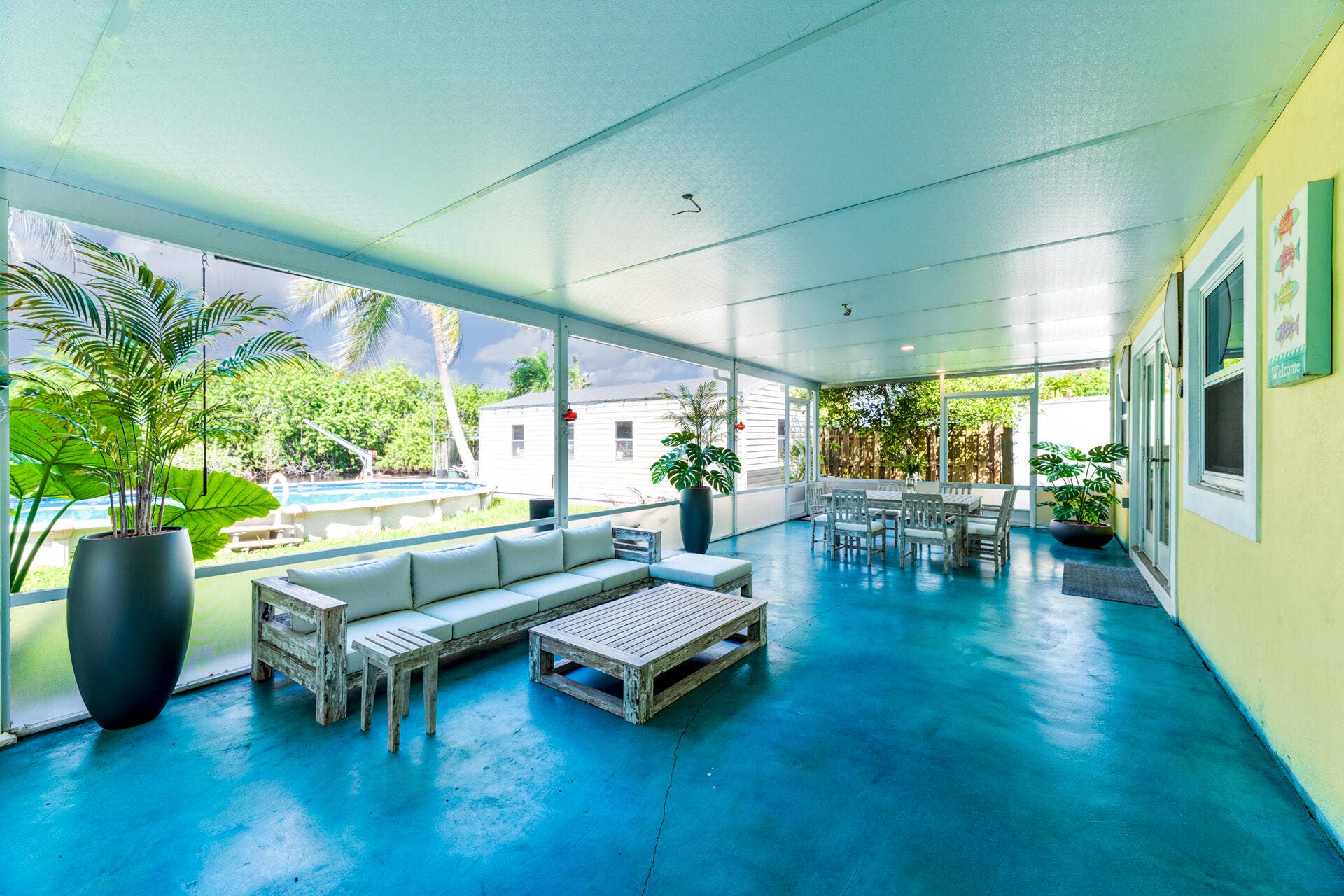 Screened-in porch featuring a painted concrete floor, recessed ceiling lighting, and exterior access doors