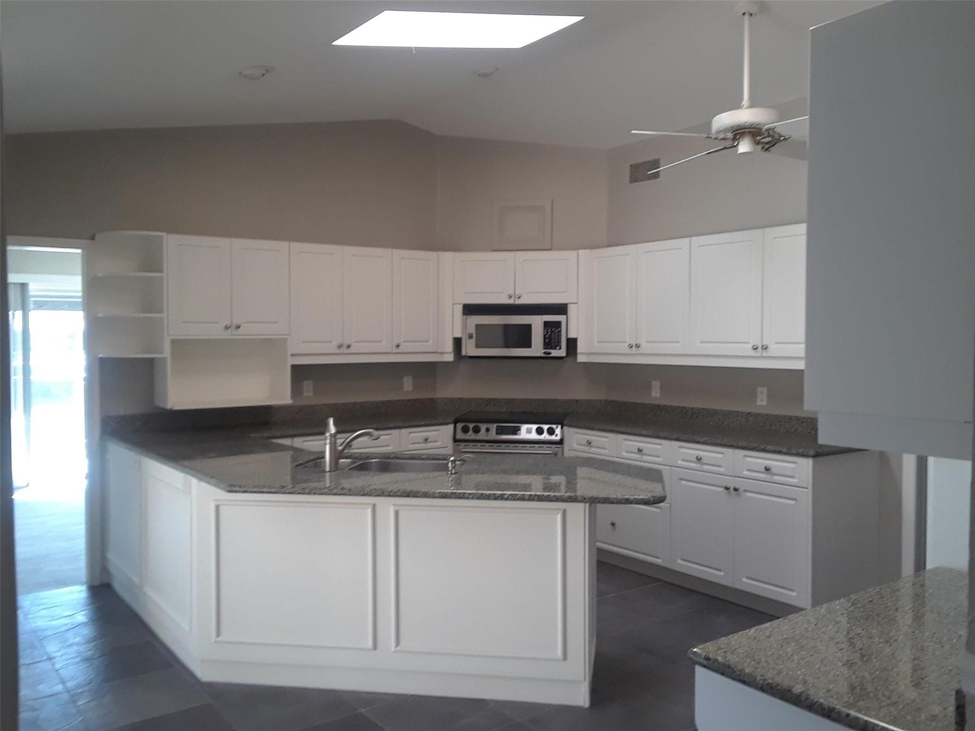 2330 NE 33RD Street, Lighthouse Point, Lighthouse Point, FL 33064 Remodeled kitchen with high ceiling and skylight