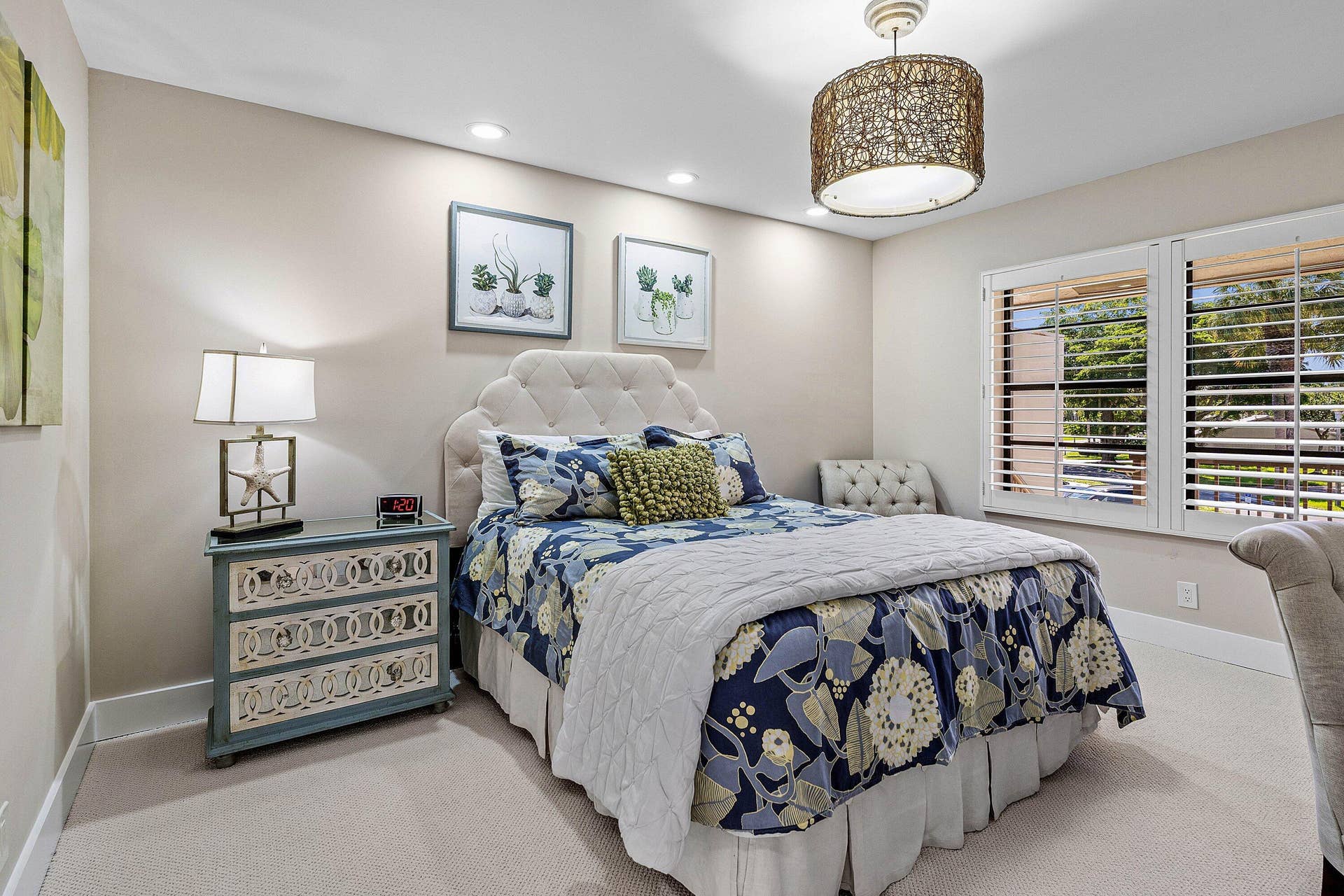 Neutral wall tones, recessed lighting, woven drum pendant light, and plantation shutters