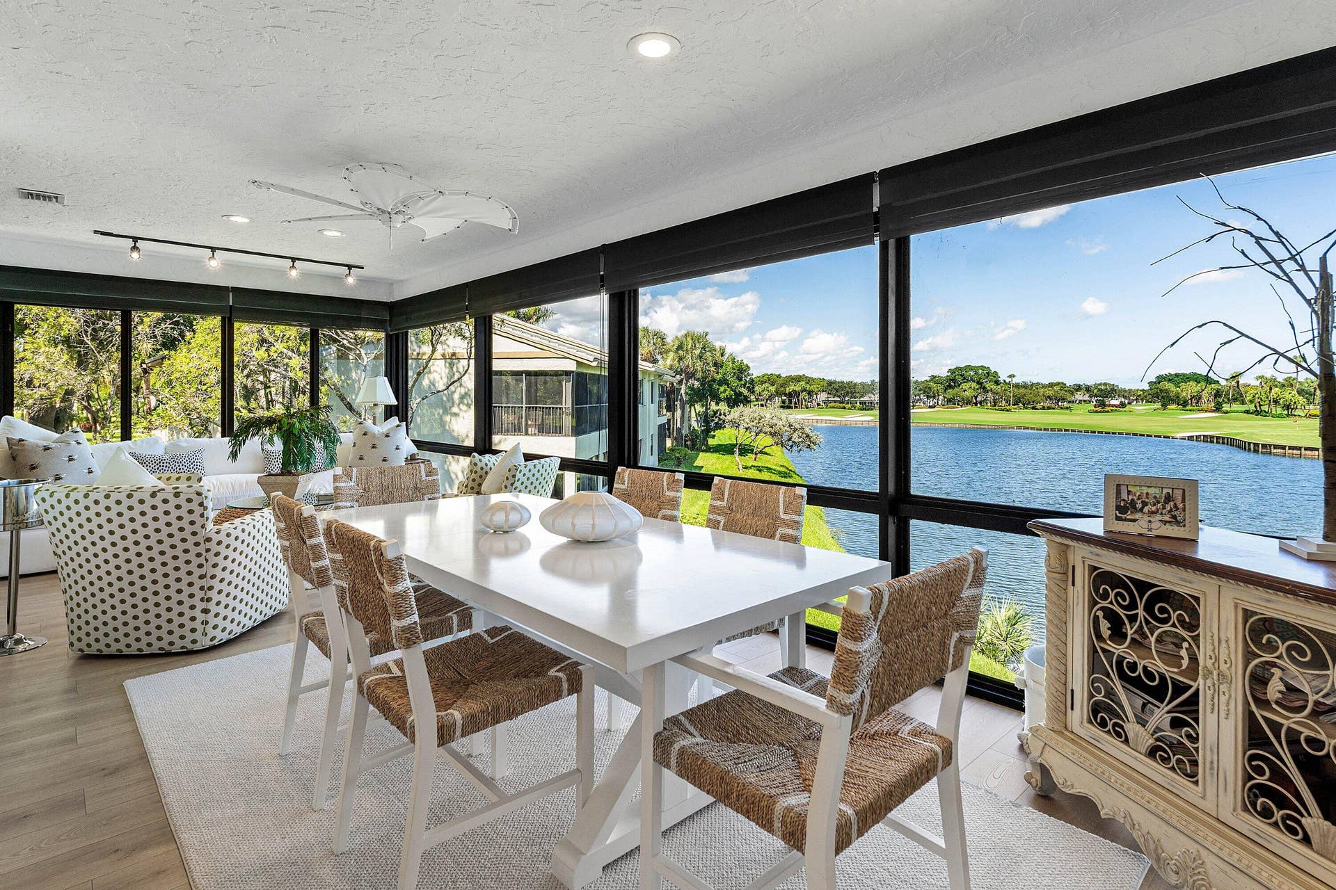 Enclosed sunroom featuring floor-to-ceiling windows, wood-finish flooring, recessed lighting, and track lighting