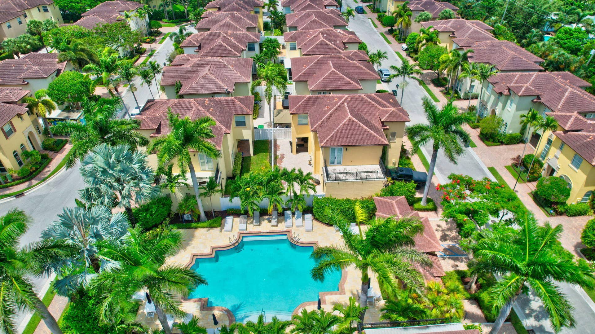 115 VIA POINCIANA Lane, Boca Raton, FL 33487 Resort-style community pool surrounded by lush landscaping