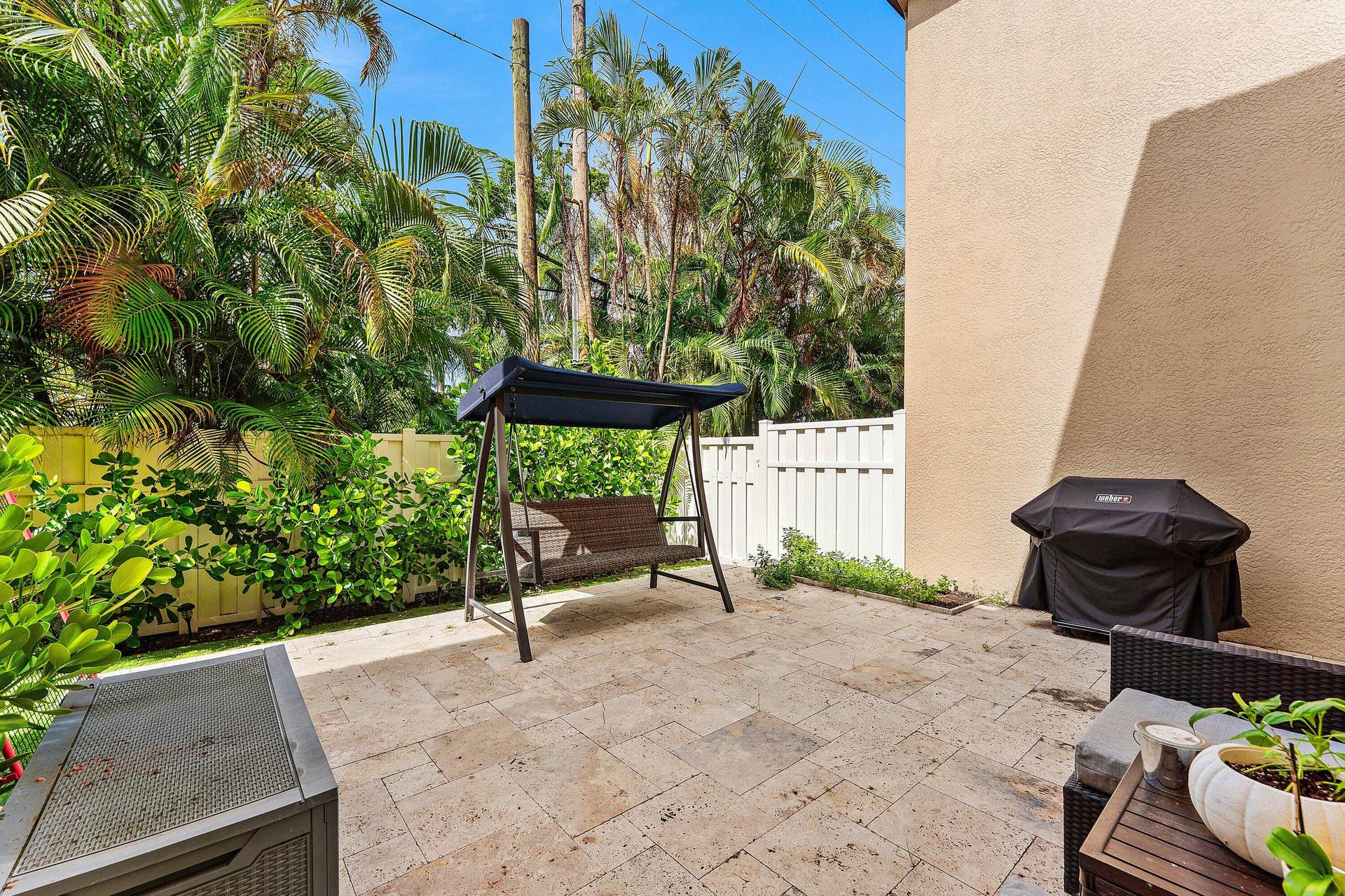 115 VIA POINCIANA Lane, Boca Raton, FL 33487 Spacious paved patio surrounded by lush tropical landscaping
