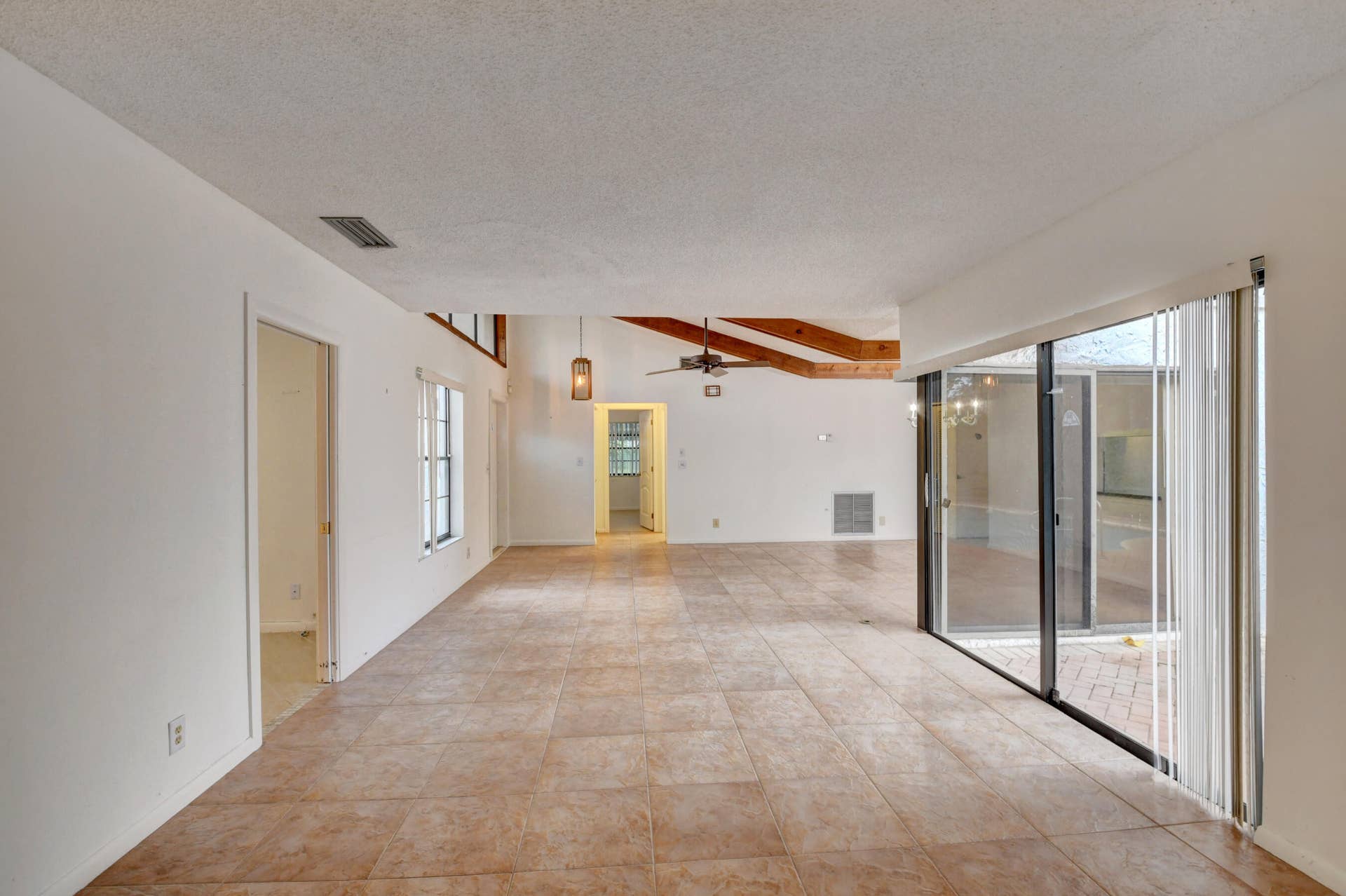 6458 Sweet Maple Lane, Boca Raton, Boca Raton, FL 33433 Expansive Living Area with Exposed Wood Beams, Tile Flooring & Abundant Natural Light