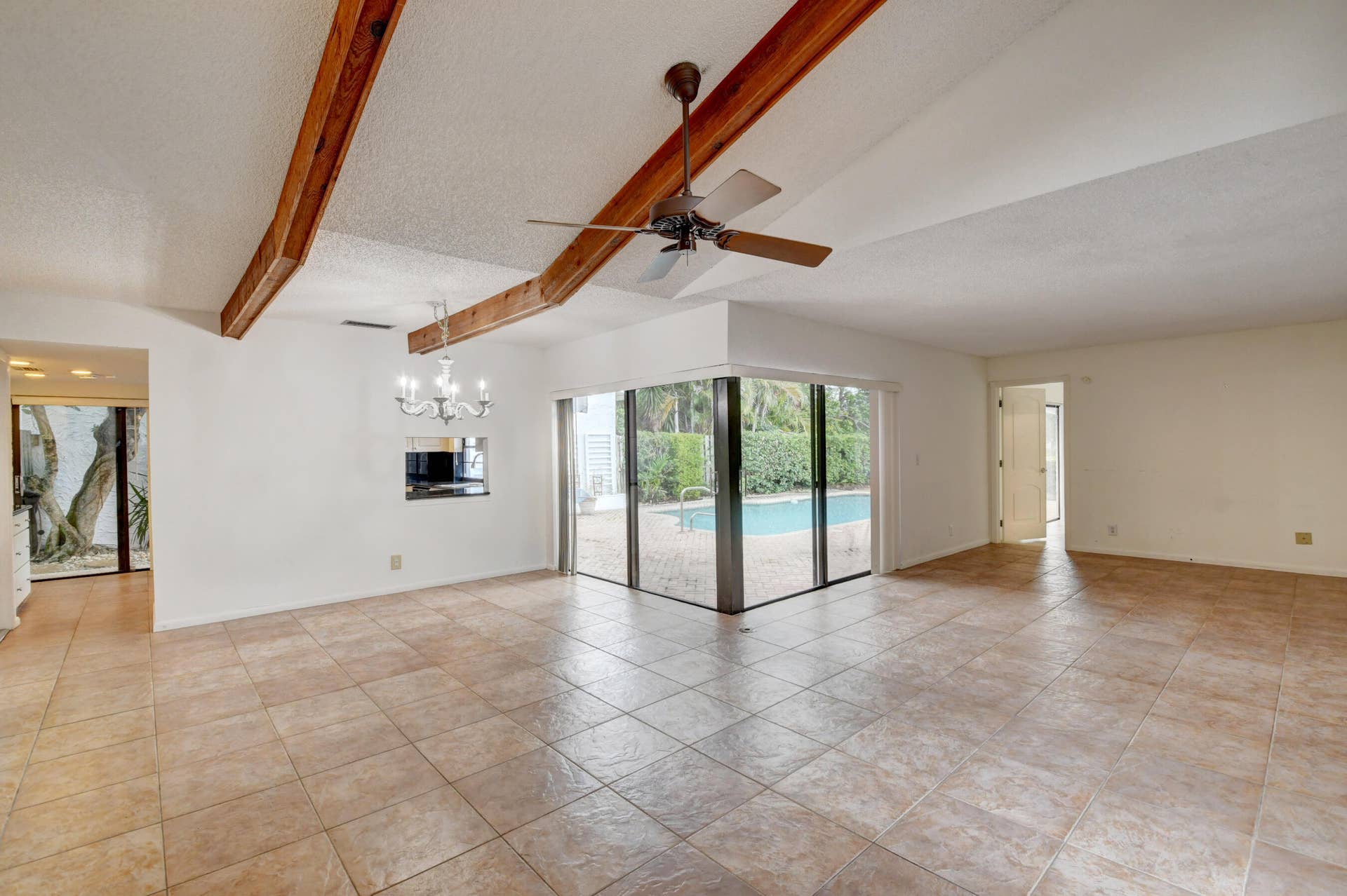 6458 Sweet Maple Lane, Boca Raton, Boca Raton, FL 33433 Expansive Living Area with Exposed Wood Beams, Tile Flooring & Abundant Natural Light