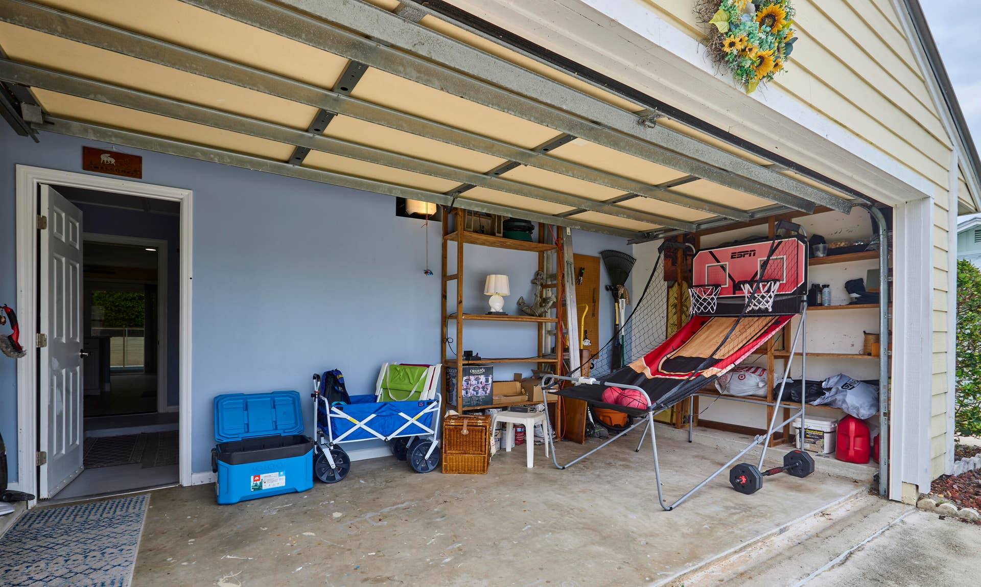 2485 NE 16TH Court, Jensen Beach, FL 34957 half of the garage is closed in with a window unit