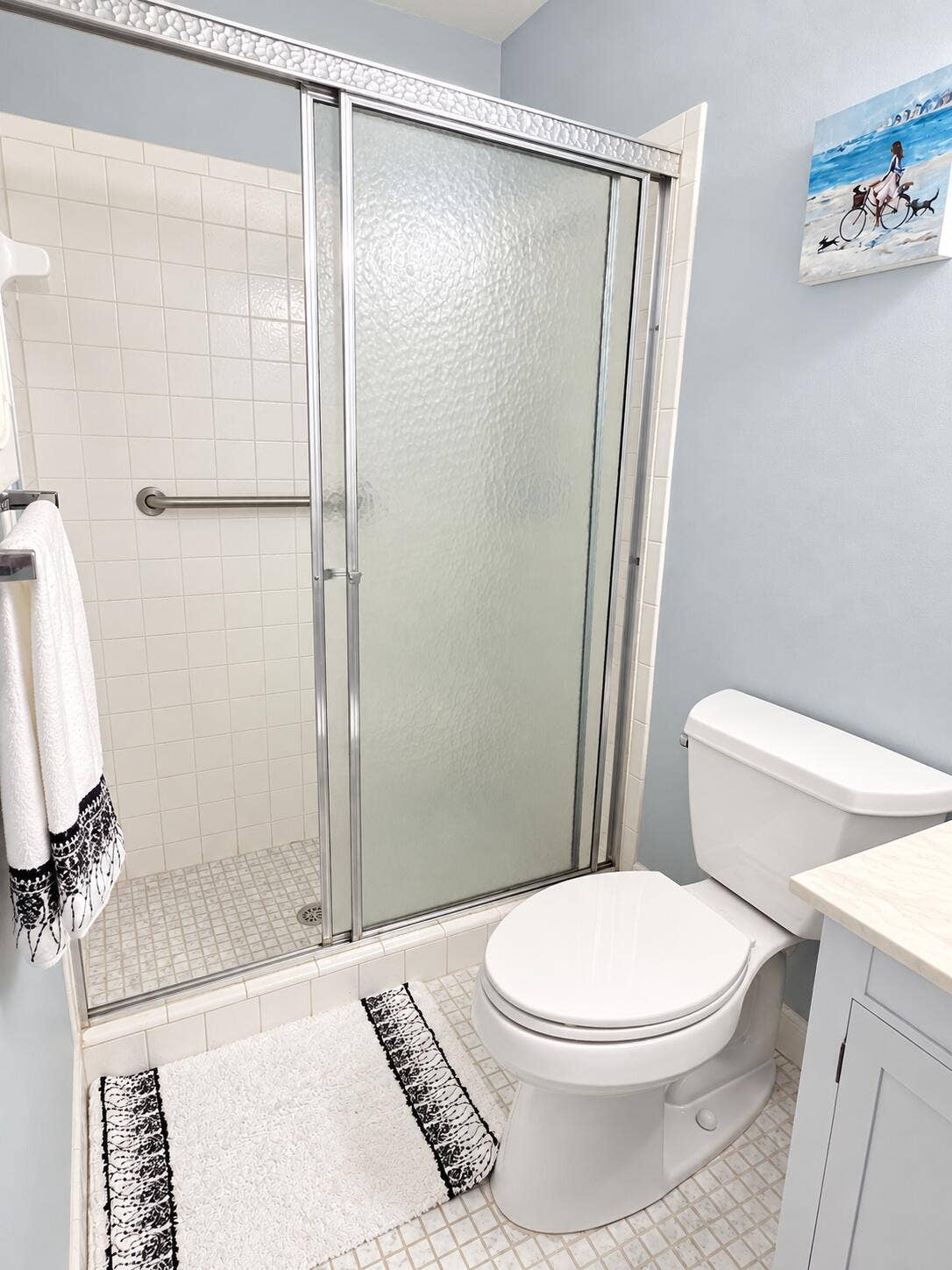 Primary bathroom has a step in shower