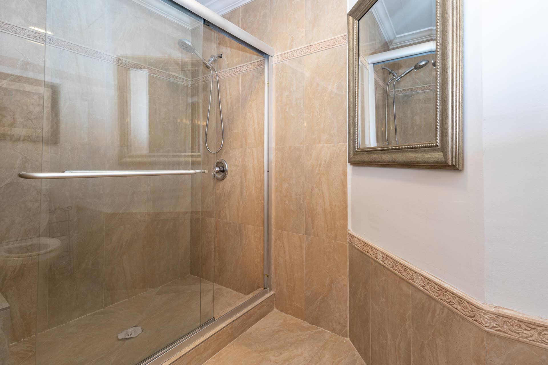 9981 W ATLANTIC Boulevard, #9981, Coral Springs, FL 33071 Spa-inspired shower featuring a frameless glass enclosure, wood-finish tile surround, and a linear floor drain