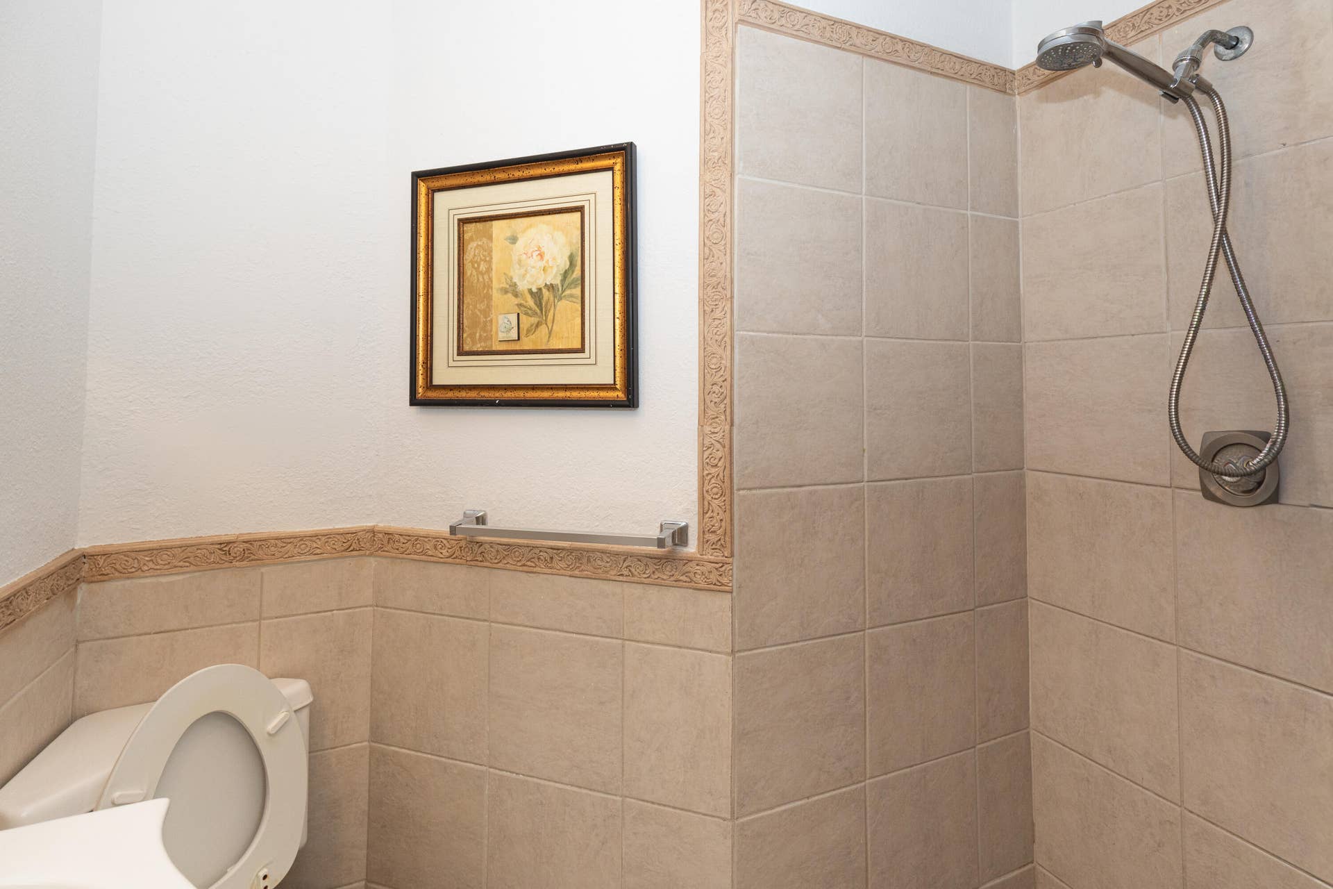 9981 W ATLANTIC Boulevard, #9981, Coral Springs, FL 33071 Tiled shower stall with a brushed nickel shower head and hand-held sprayer