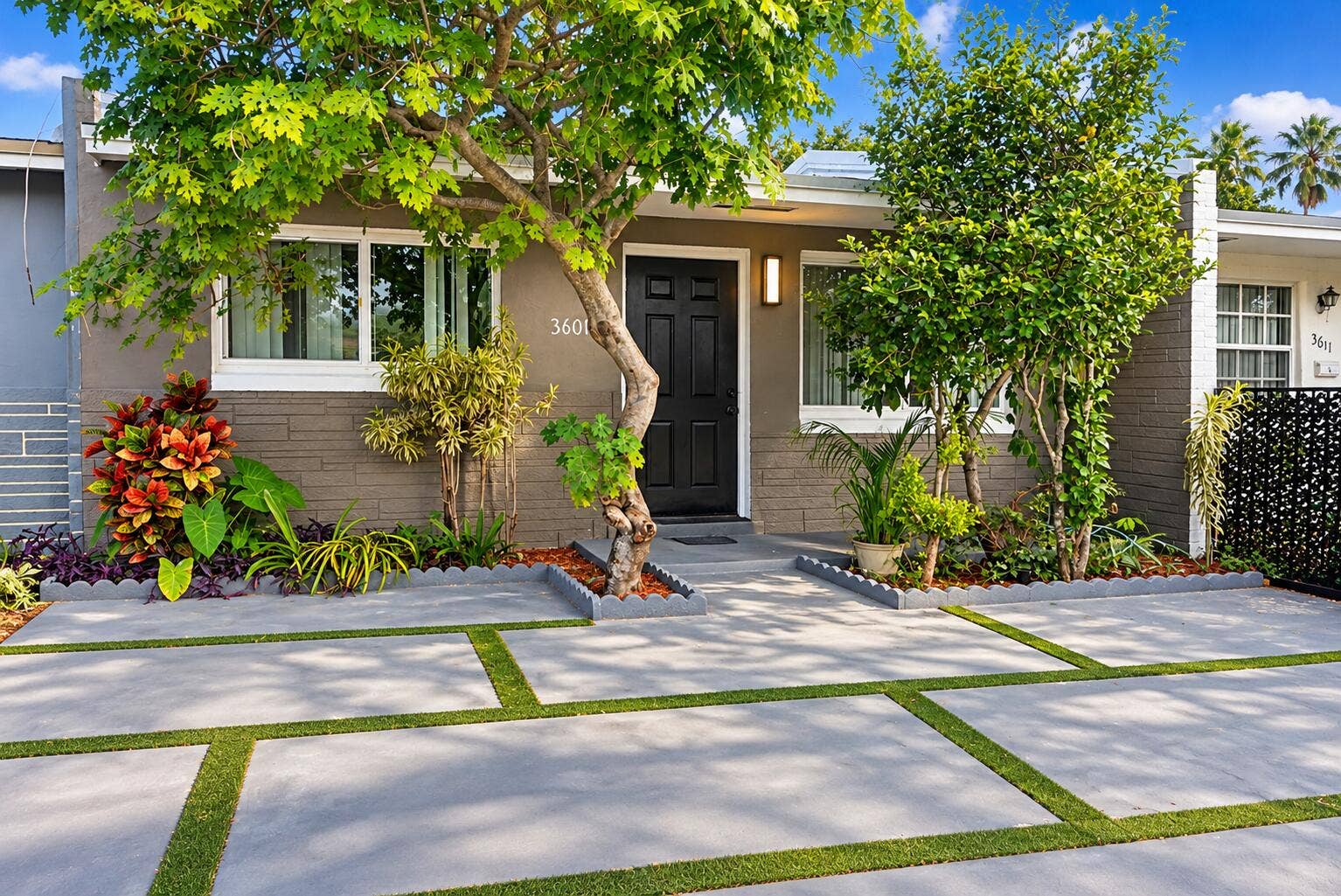 3601 SW 54th Avenue, West Park, FL 33023 Exterior facade featuring concrete paver driveway with turf accents, mature landscaping.