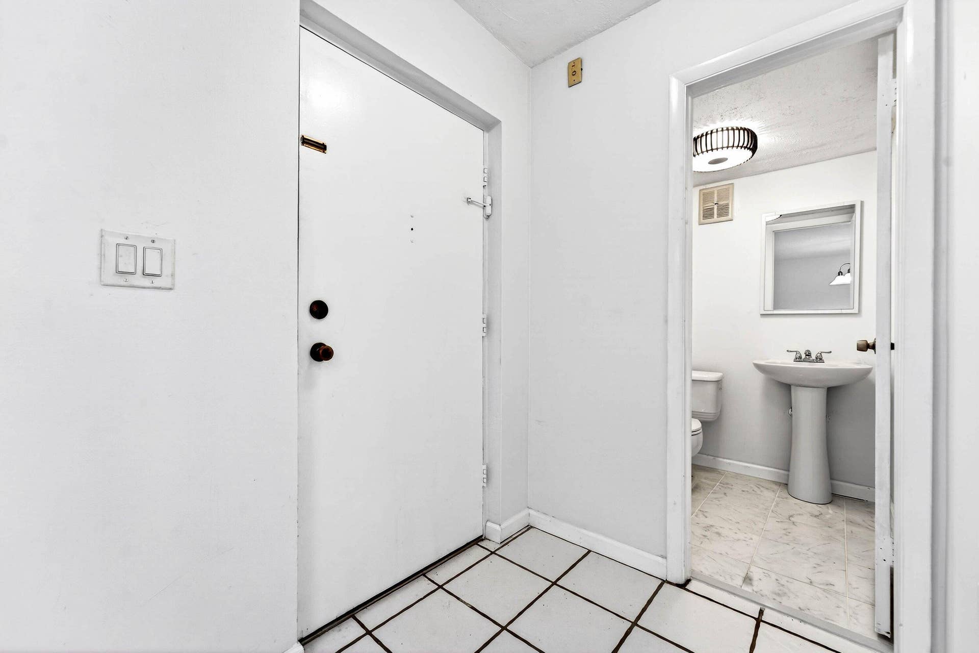 Condo entrance and half bathroom