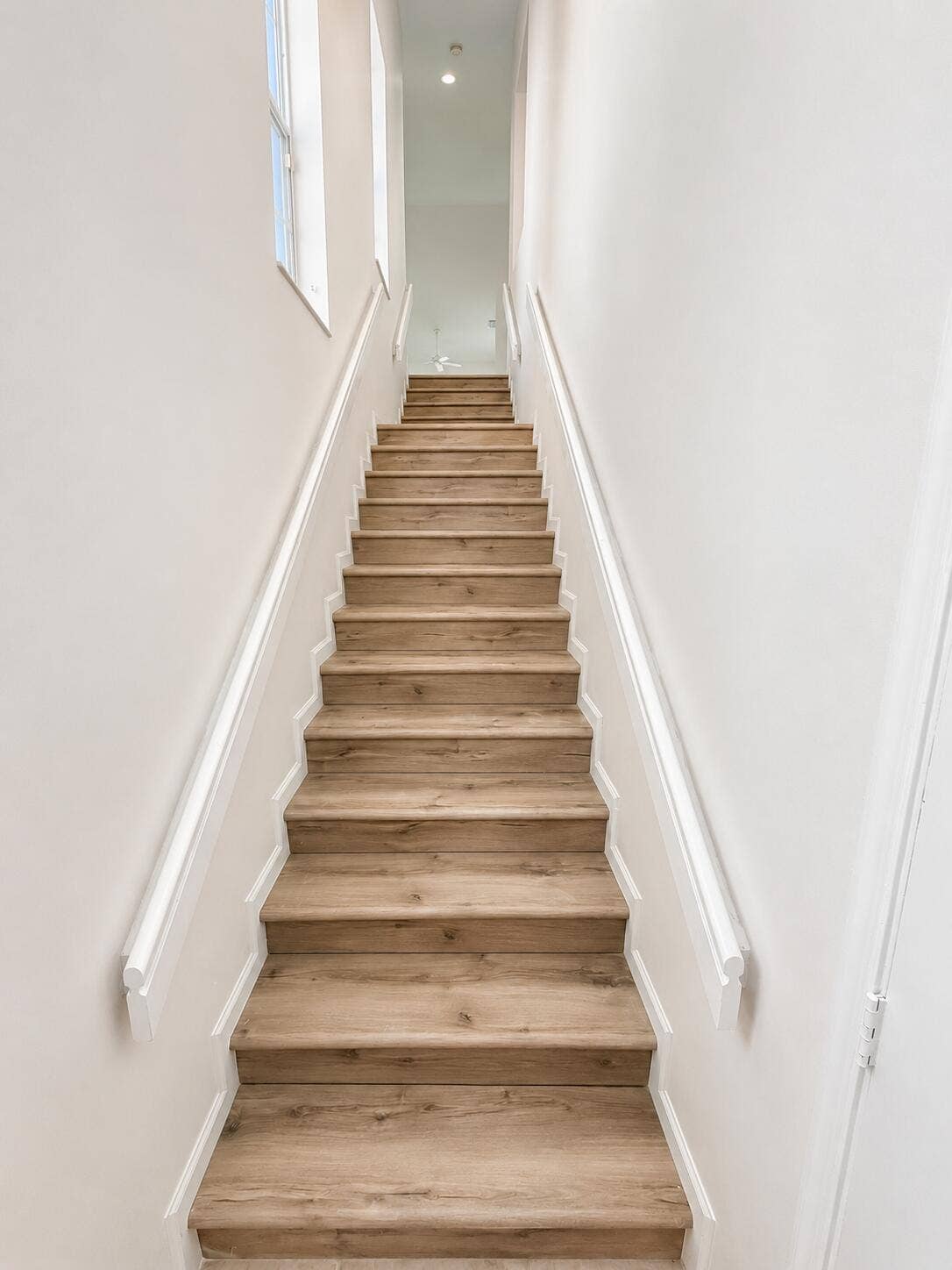 6560 VILLA SONRISA Drive, #1321, Boca Raton, FL 33433 Staircase featuring vinyl -wood alike finish treads and white-painted handrails
