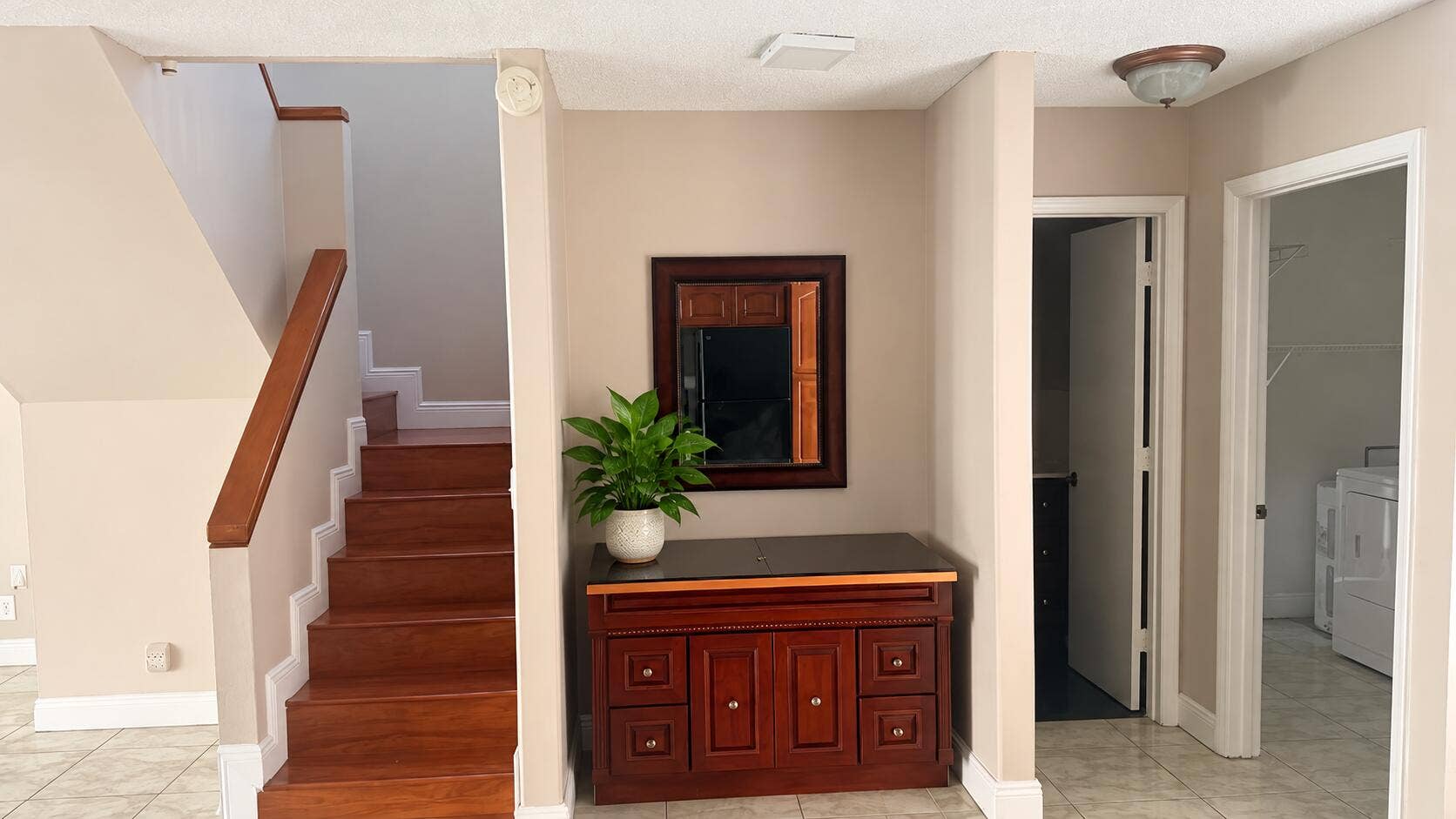8701 SW 30TH Street, #205, Davie, FL 33328 Elegant Foyer with Staircase and Plant