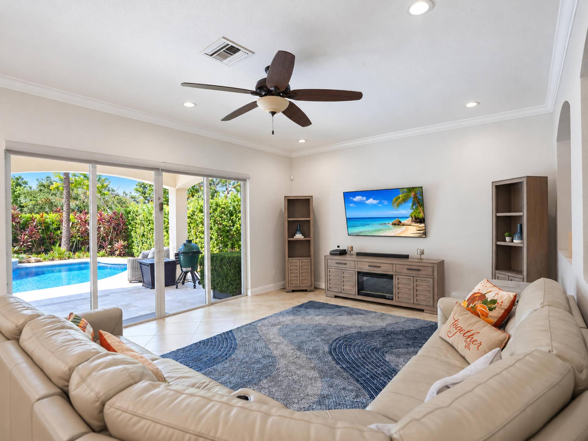 8601 Waterside Court, Parkland, FL 33076 Living area featuring large sliding glass doors, neutral tile flooring, recessed lighting, crown molding, and a ceiling fan