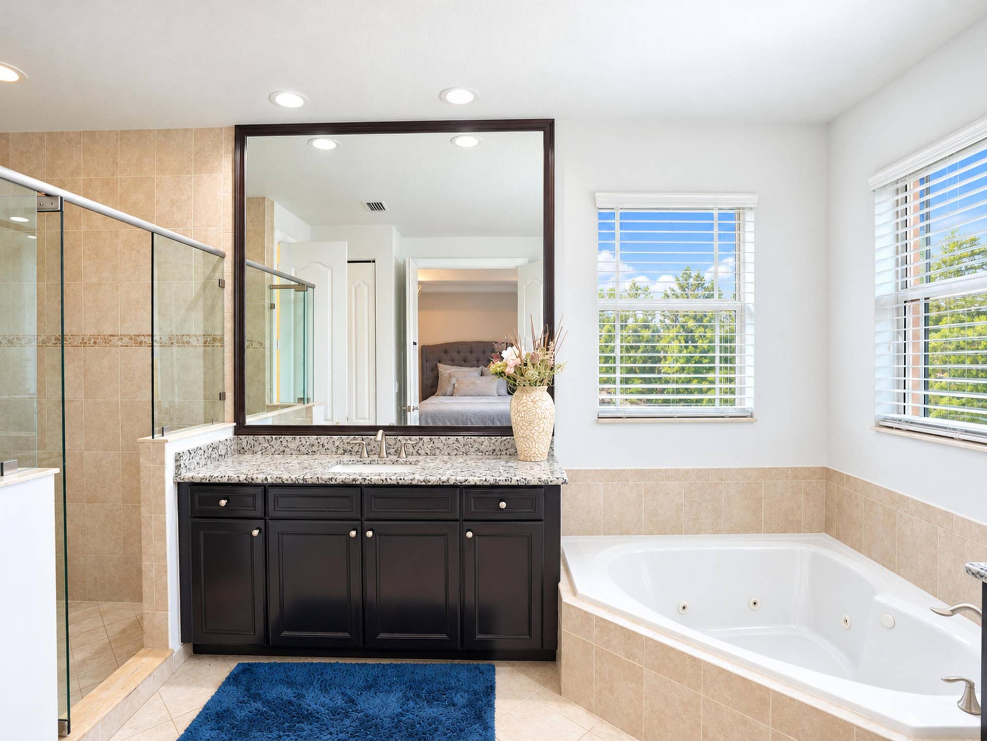 8601 Waterside Court, Parkland, FL 33076 Bathroom featuring a dark wood vanity with stone-finish countertop, walk-in shower with a glass enclosure, jetted soaking tub, recessed lighting, and tile flooring