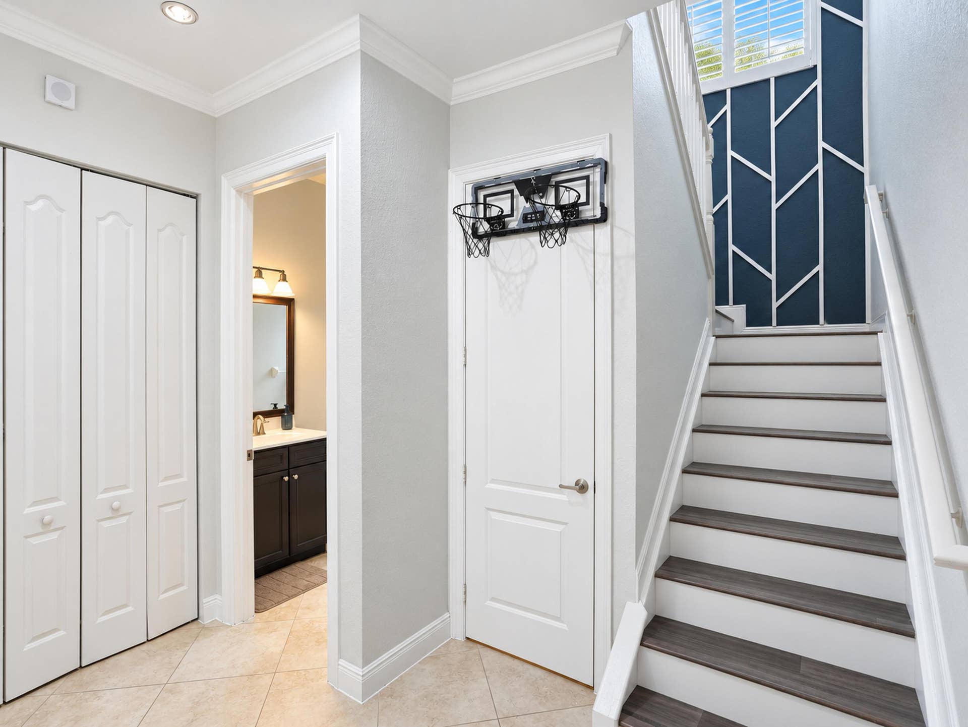 8601 Waterside Court, Parkland, FL 33076 Staircase featuring wood-finish treads, white risers, and decorative wall paneling