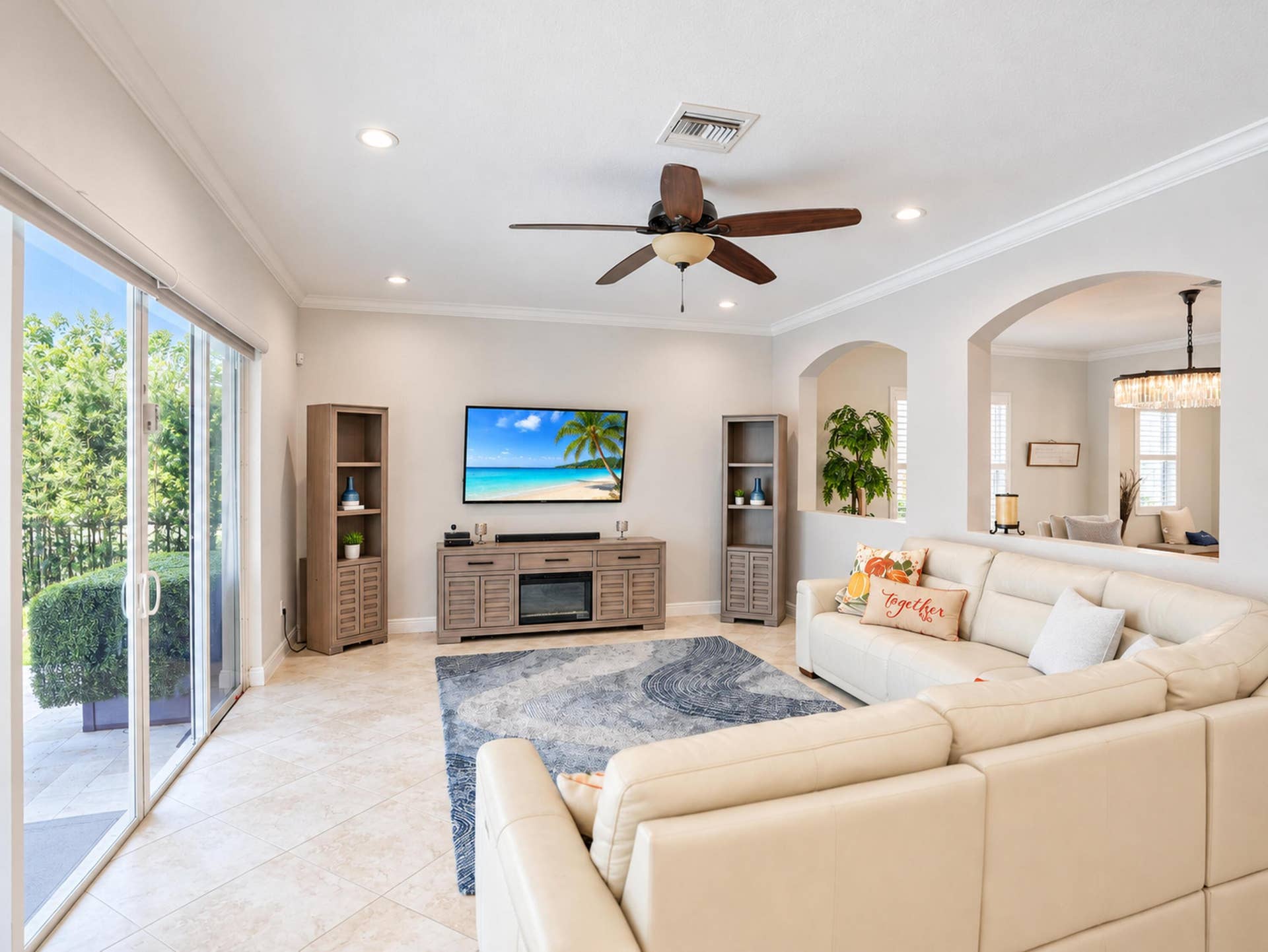 8601 Waterside Court, Parkland, FL 33076 Living area featuring tile flooring, crown molding, recessed lighting, ceiling fan, and sliding glass doors