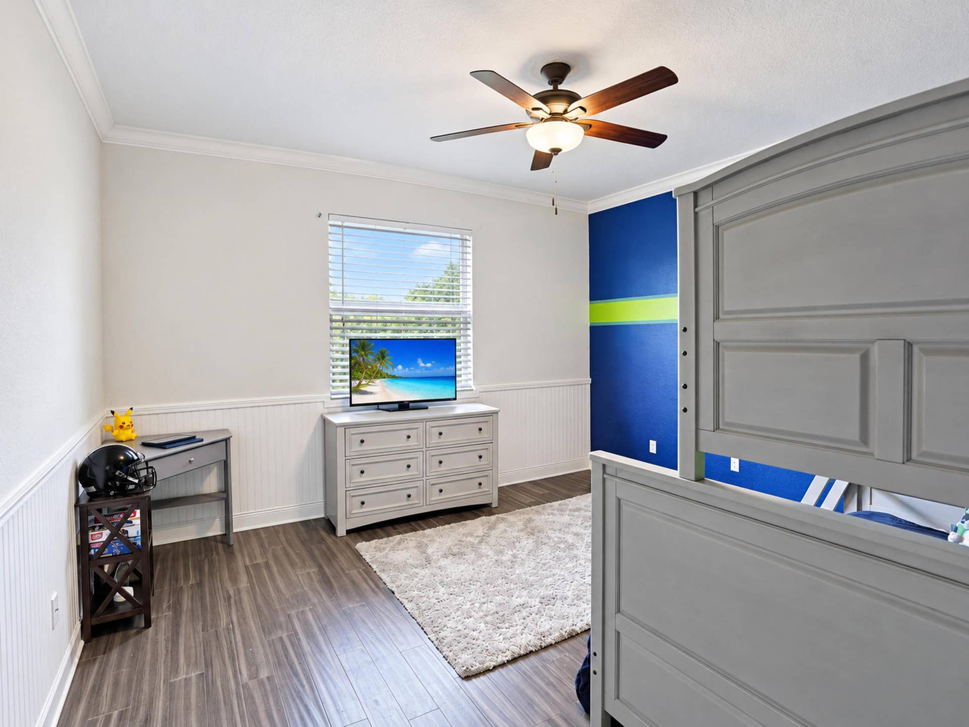 8601 Waterside Court, Parkland, FL 33076 Room featuring wood-finish flooring, white wainscoting, crown molding, and a ceiling fan with integrated lighting