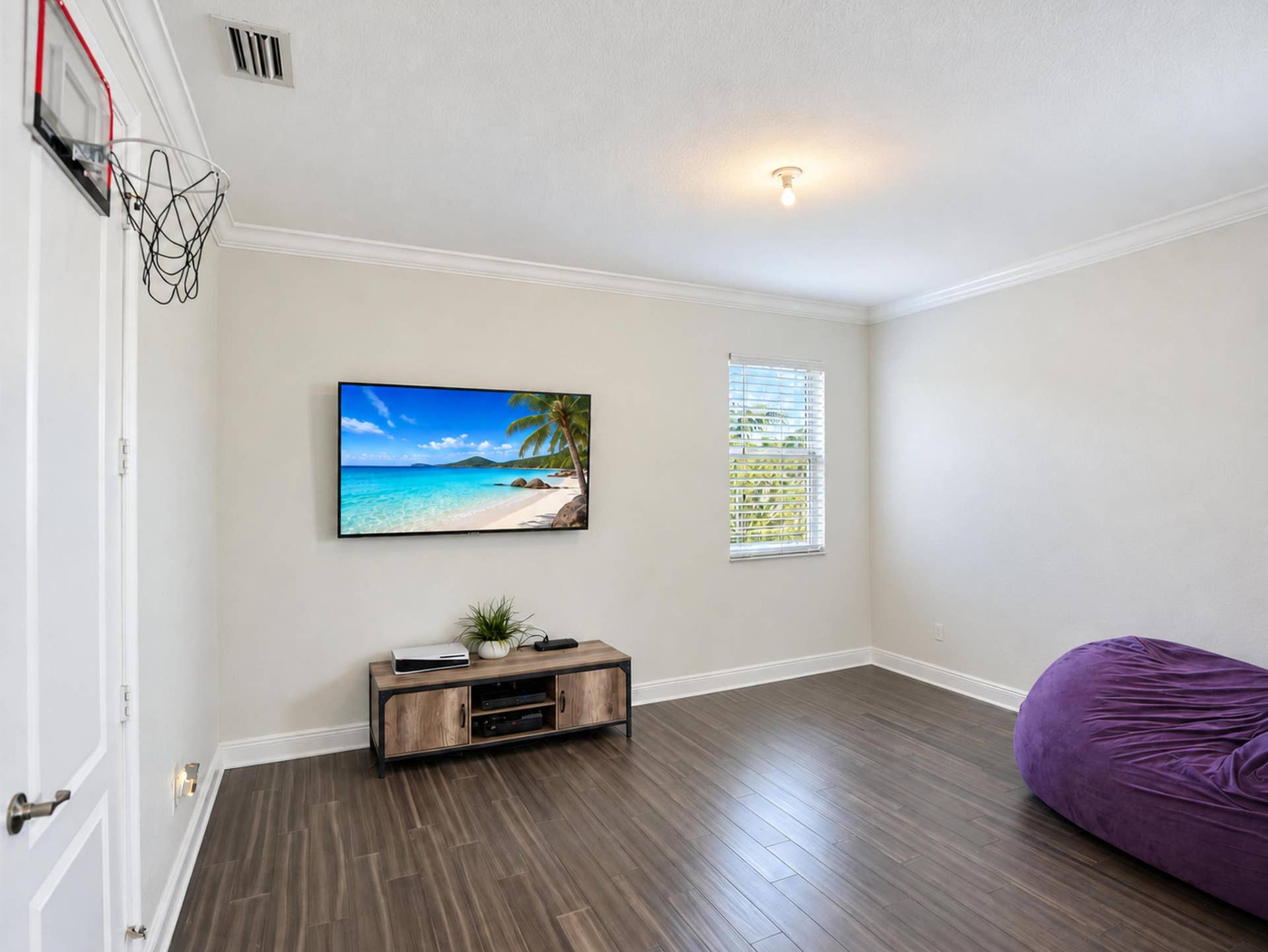 8601 Waterside Court, Parkland, FL 33076 Room featuring wood-finish flooring, crown molding, and a single-pane window with white horizontal blinds