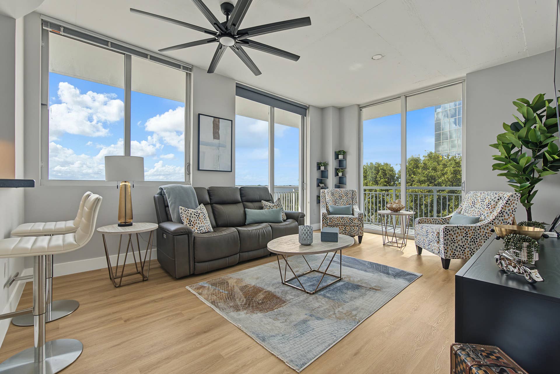 300 S AUSTRALIAN Avenue, #307, West Palm Beach, West Palm Beach, FL 33401 relaxing living room surrounded by large windows and wrap-around balcony.