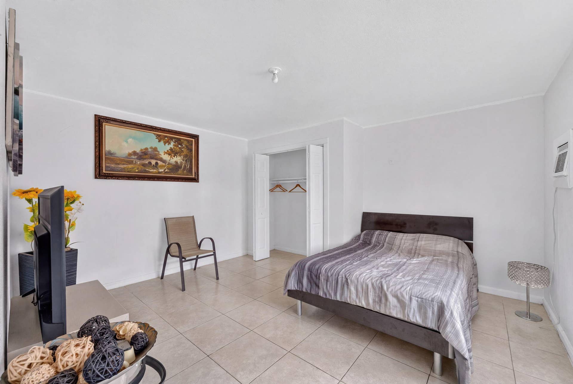 1224 NE 5TH Avenue, Fort Lauderdale, FL 33304 Room with neutral walls, large-format tile flooring, and a built-in closet with folding doors