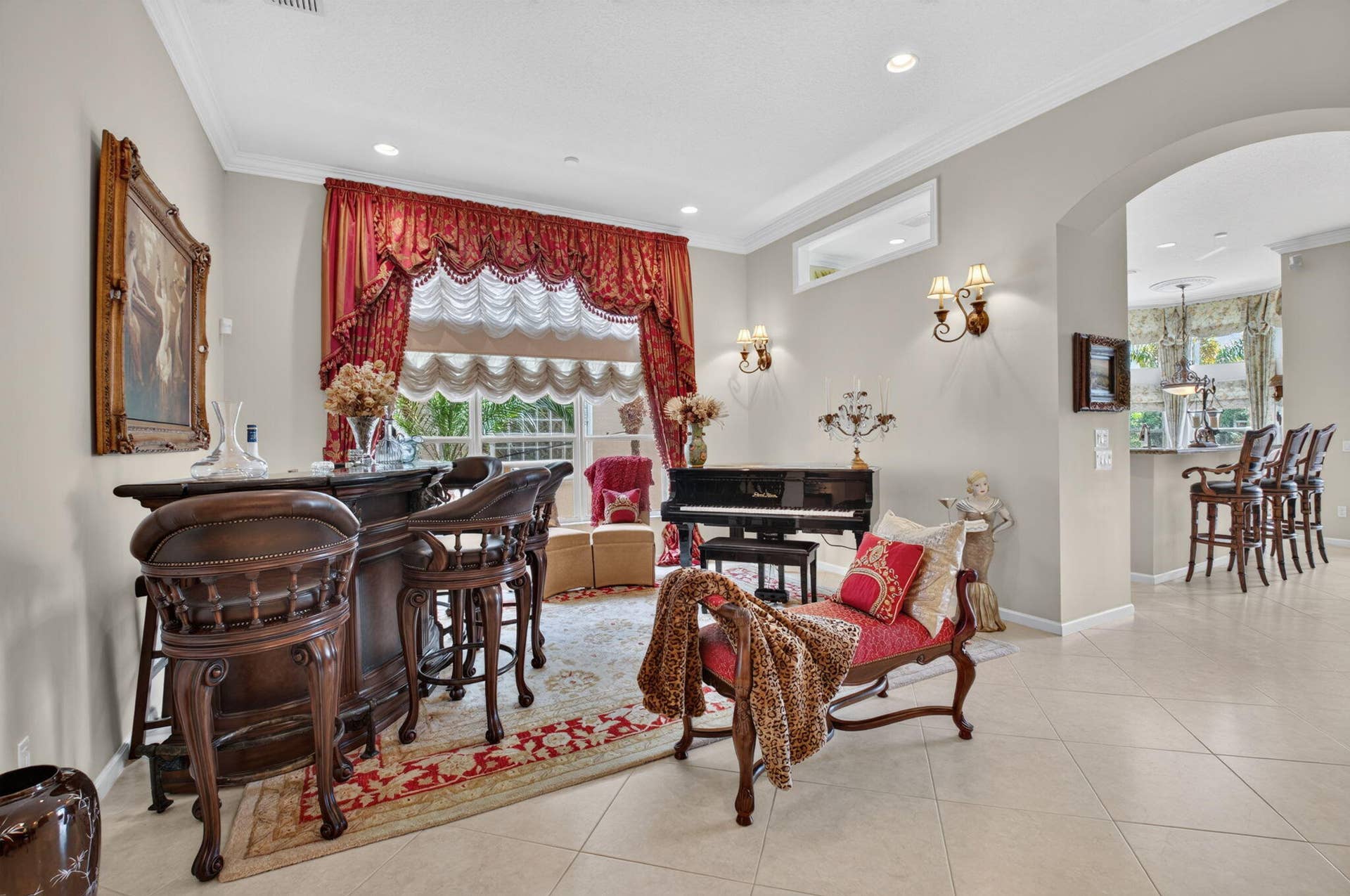 6874 Venidita Beach Drive, Delray Beach, FL 33446 Spacious interior featuring large-format tile flooring, recessed ceiling lighting, crown molding, and two wall-mounted decorative light fixtures