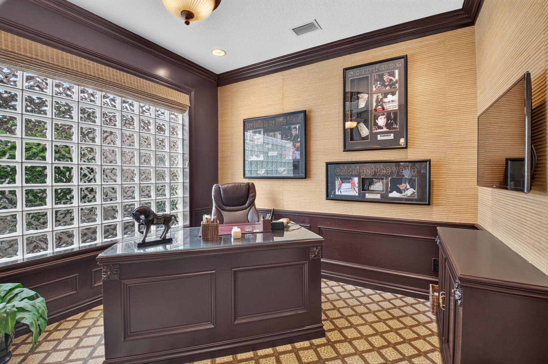 6874 Venidita Beach Drive, Delray Beach, FL 33446 Room featuring glass block windows, grasscloth wall coverings, custom dark-toned wainscoting, intricate crown molding, and geometric tile flooring