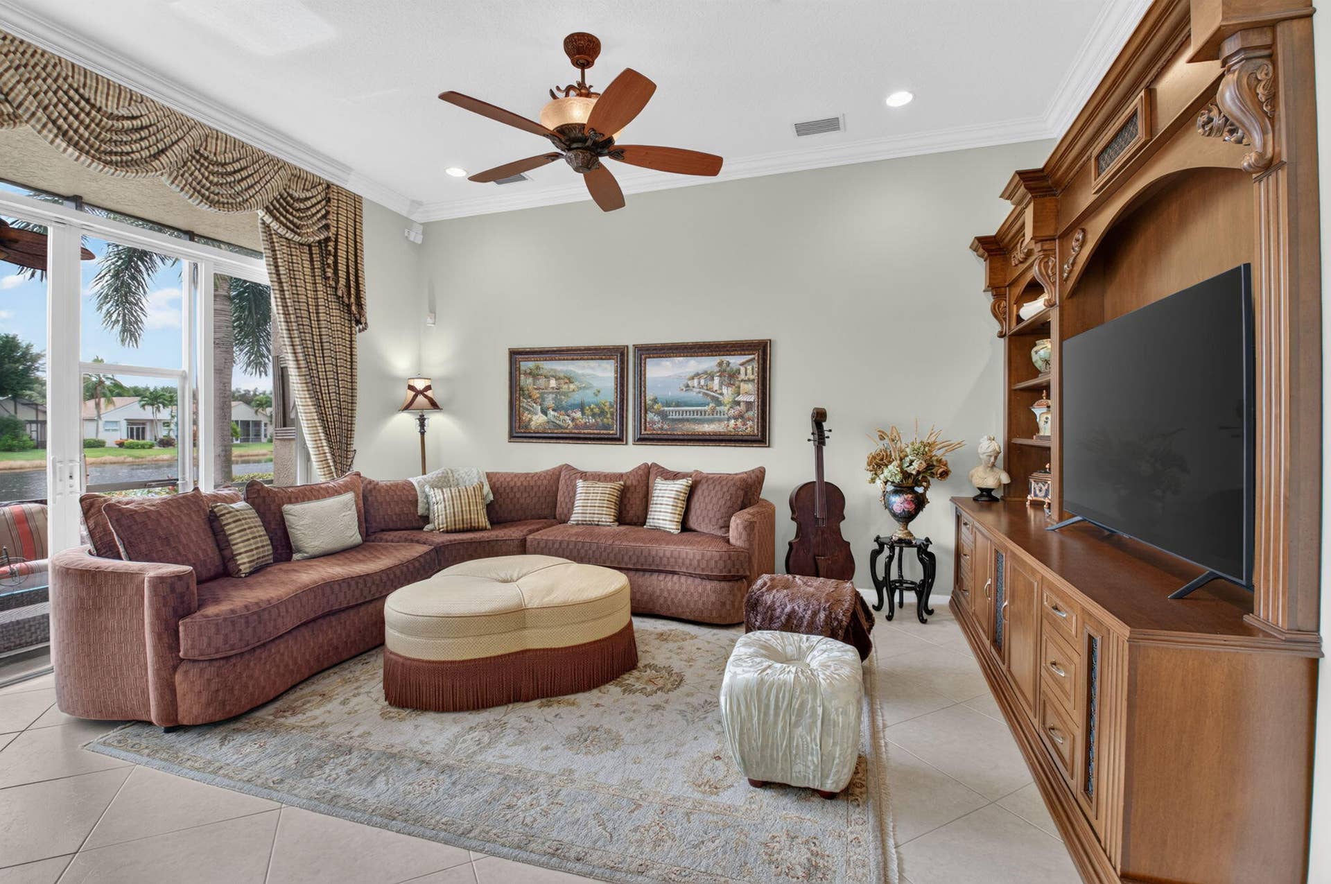 6874 Venidita Beach Drive, Delray Beach, FL 33446 Living area featuring ceramic tile flooring, built-in wooden cabinetry, recessed lighting, and a ceiling fan