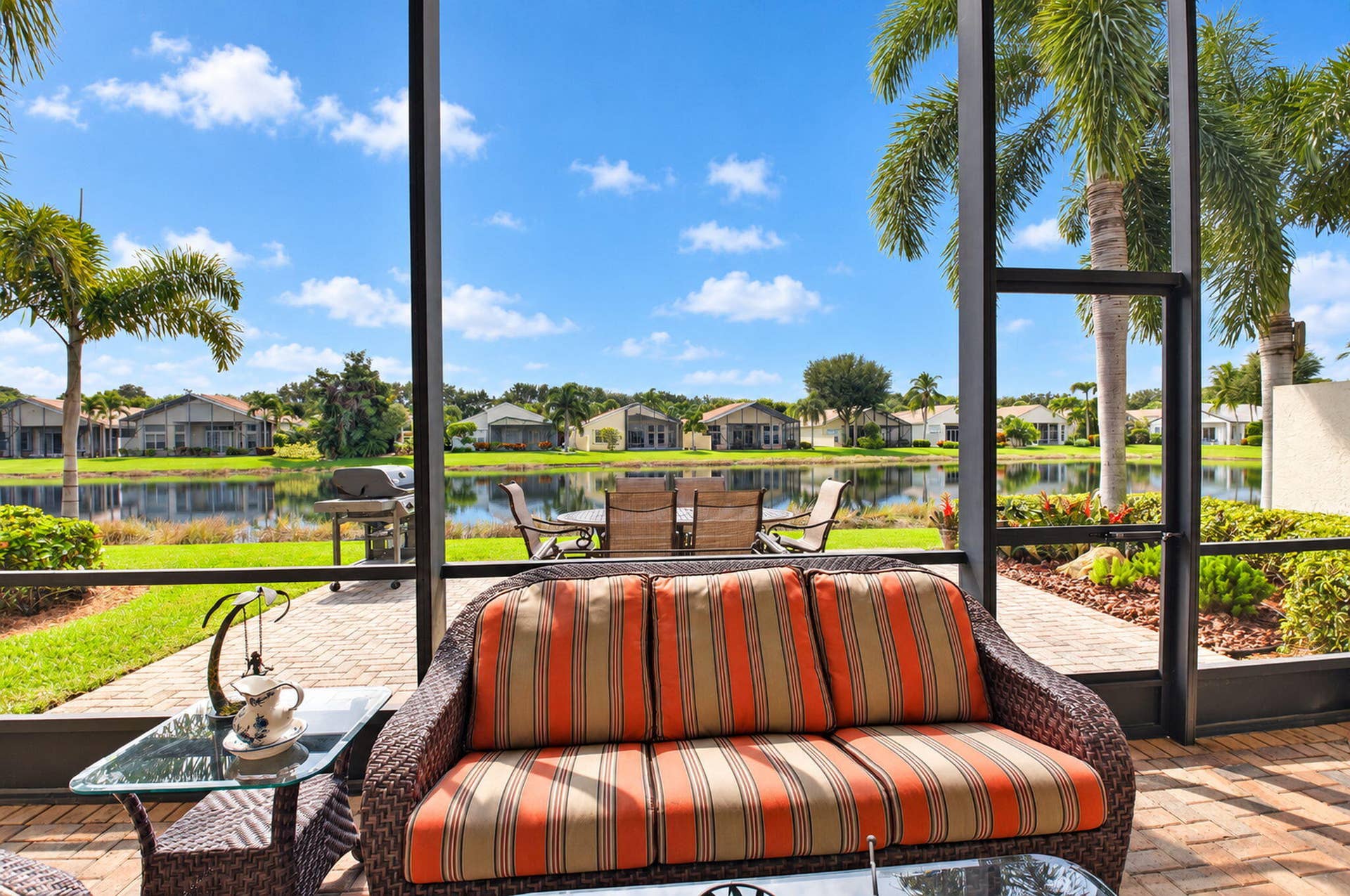 6874 Venidita Beach Drive, Delray Beach, FL 33446 Screened-in lanai featuring paver flooring and water frontage