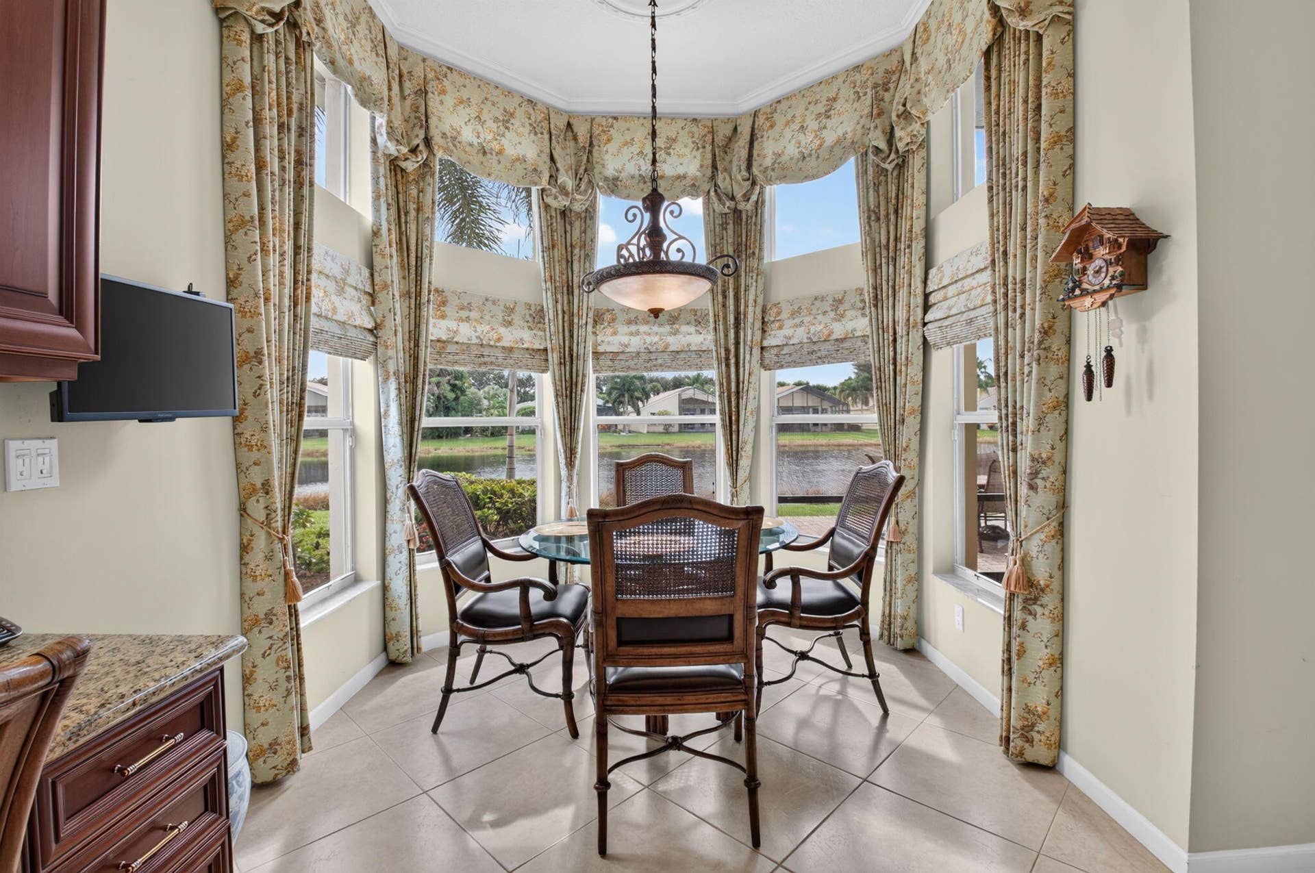 6874 Venidita Beach Drive, Delray Beach, FL 33446 Bay window featuring floor-to-ceiling windows, tile flooring, and a multi-light metal chandelier
