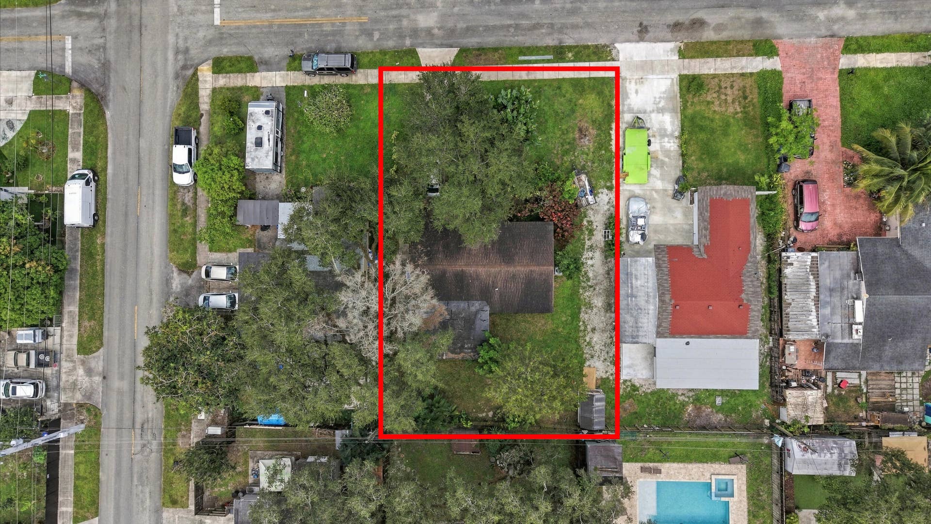 6660 FREEDOM Street, Hollywood, FL 33024 Aerial view of a rectangular corner lot featuring mature trees and a gravel driveway