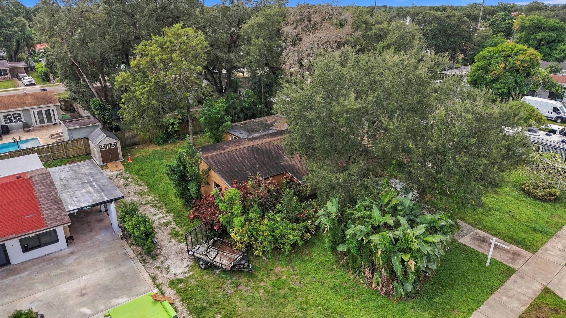 6660 FREEDOM Street, Hollywood, FL 33024 Expansive lot featuring mature shade trees, established landscaping, and a detached storage shed